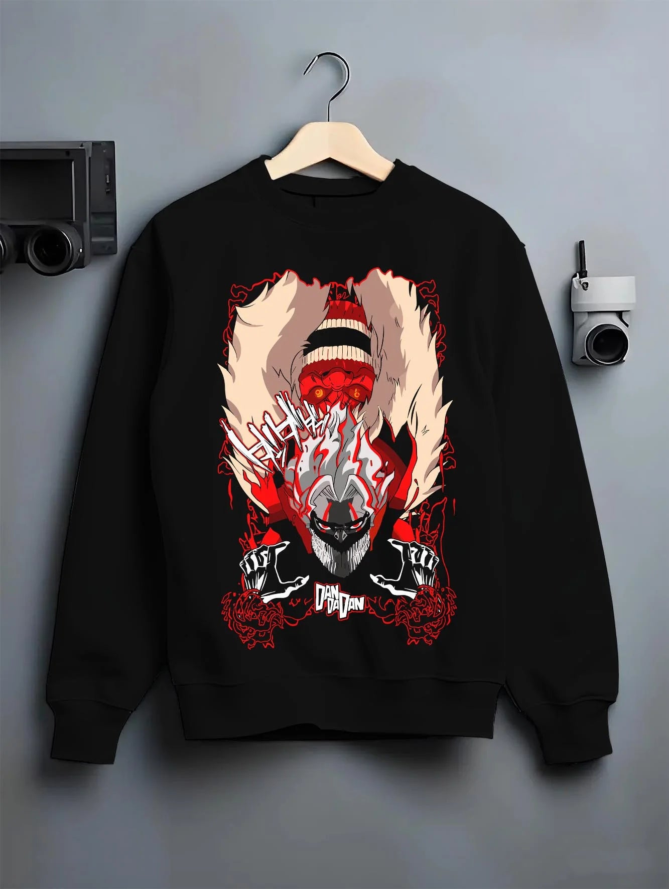 Black crewneck sweatshirt on hanger with Turbo Granny Dandadan Hoodie Retro Yokai Anime Horror graphic bold anime graphic.