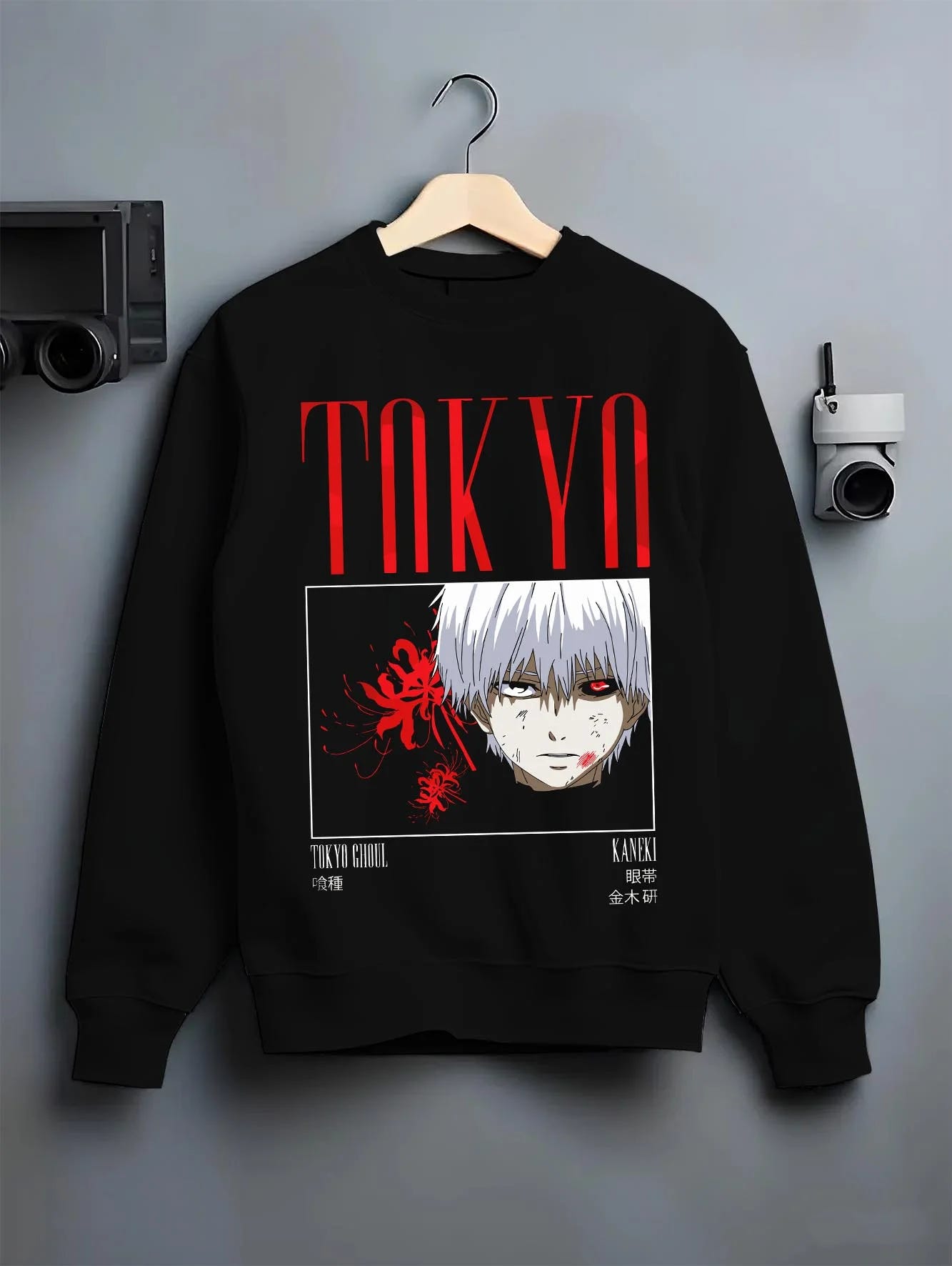 Black crewneck sweatshirt on hanger with Ken Kaneki Hoodie Tokyo Ghoul One Eyed Mask graphic streetwear graphic.