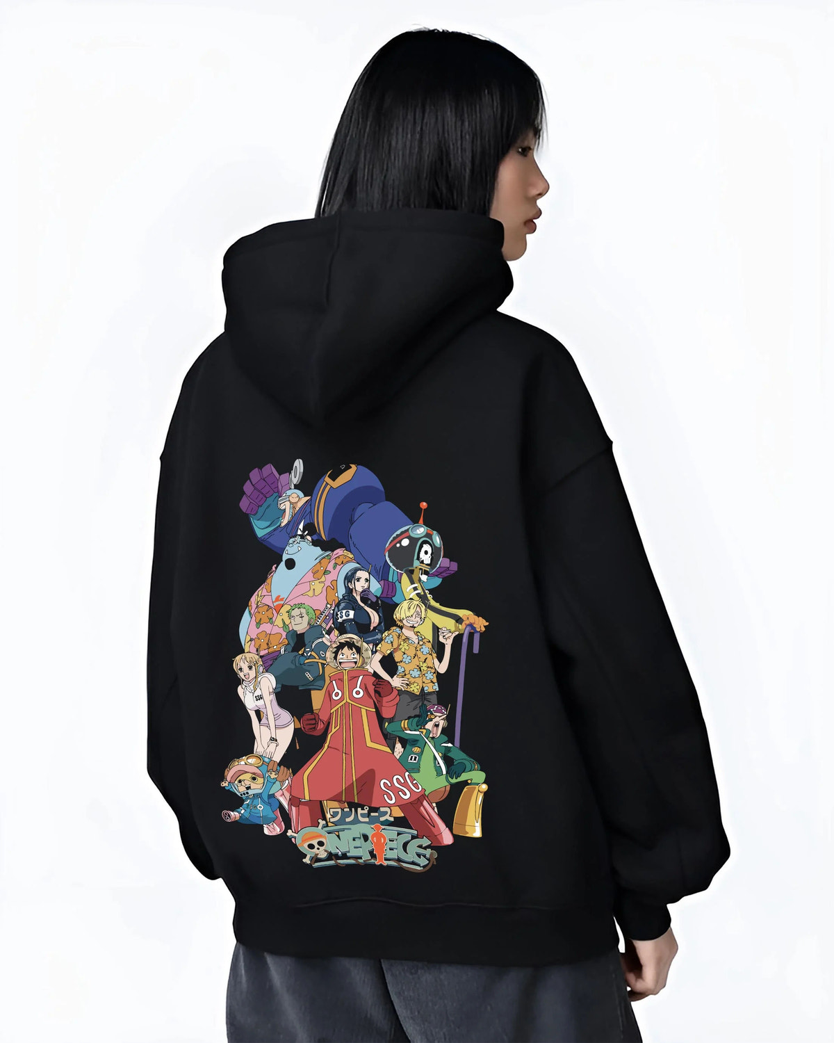 Black hoodie worn by female model from the back featuring Straw Hat Crew Egghead Island One Piece artwork.