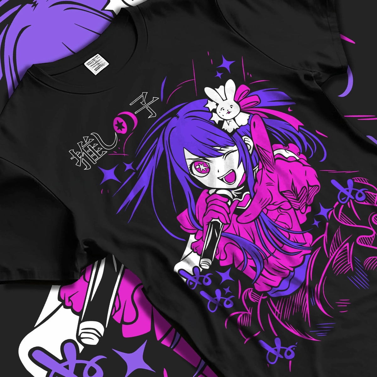 Black T-shirt laid flat with natural folds featuring Ai Hoshino microphone stage portrait Oshi no Ko artwork.