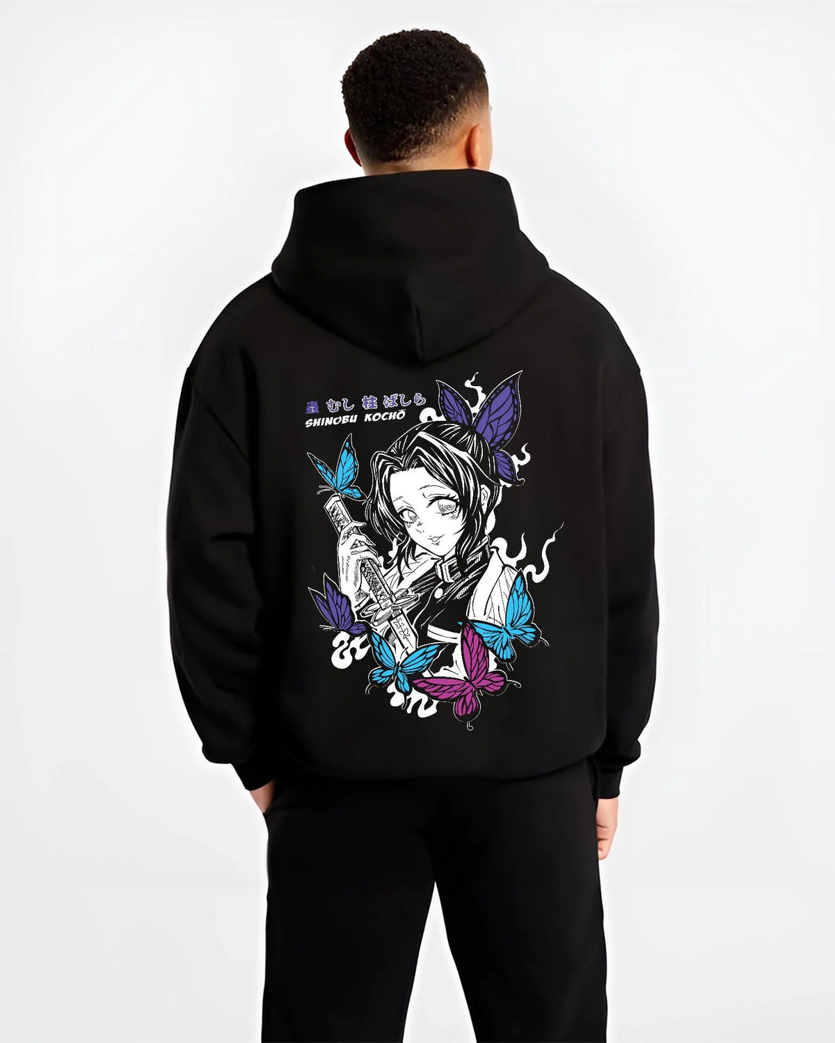 Black hoodie worn by male model from the back featuring Shinobu Kocho butterfly poison Demon Slayer artwork.