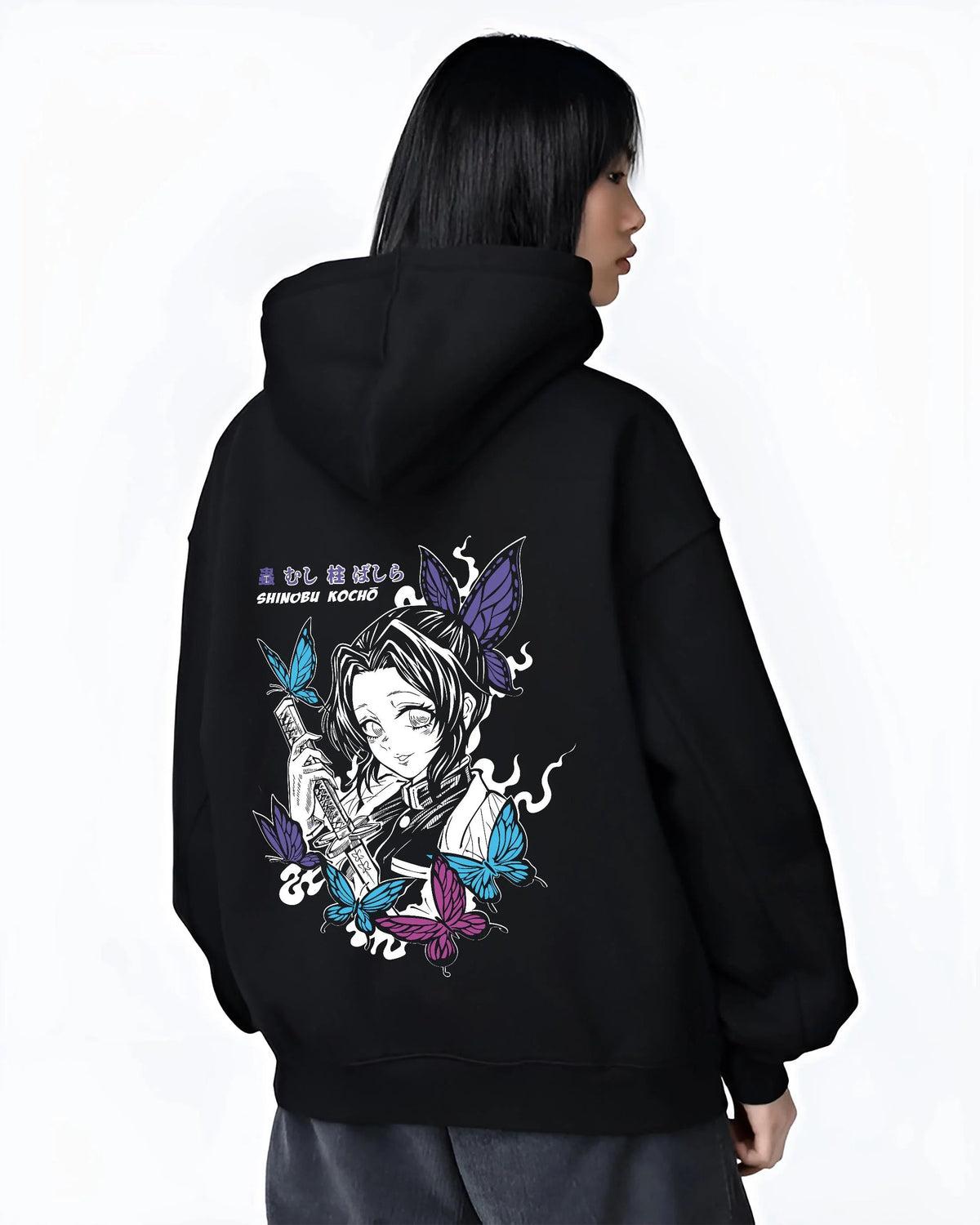Black hoodie worn by female model from the back featuring Shinobu Kocho butterfly poison Demon Slayer artwork.