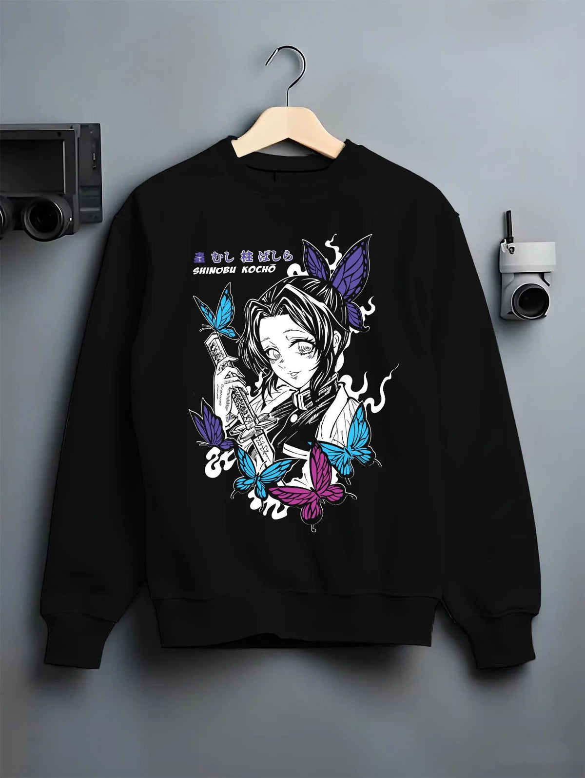 Black crewneck sweatshirt on hanger featuring Shinobu Kocho butterfly poison Demon Slayer artwork.