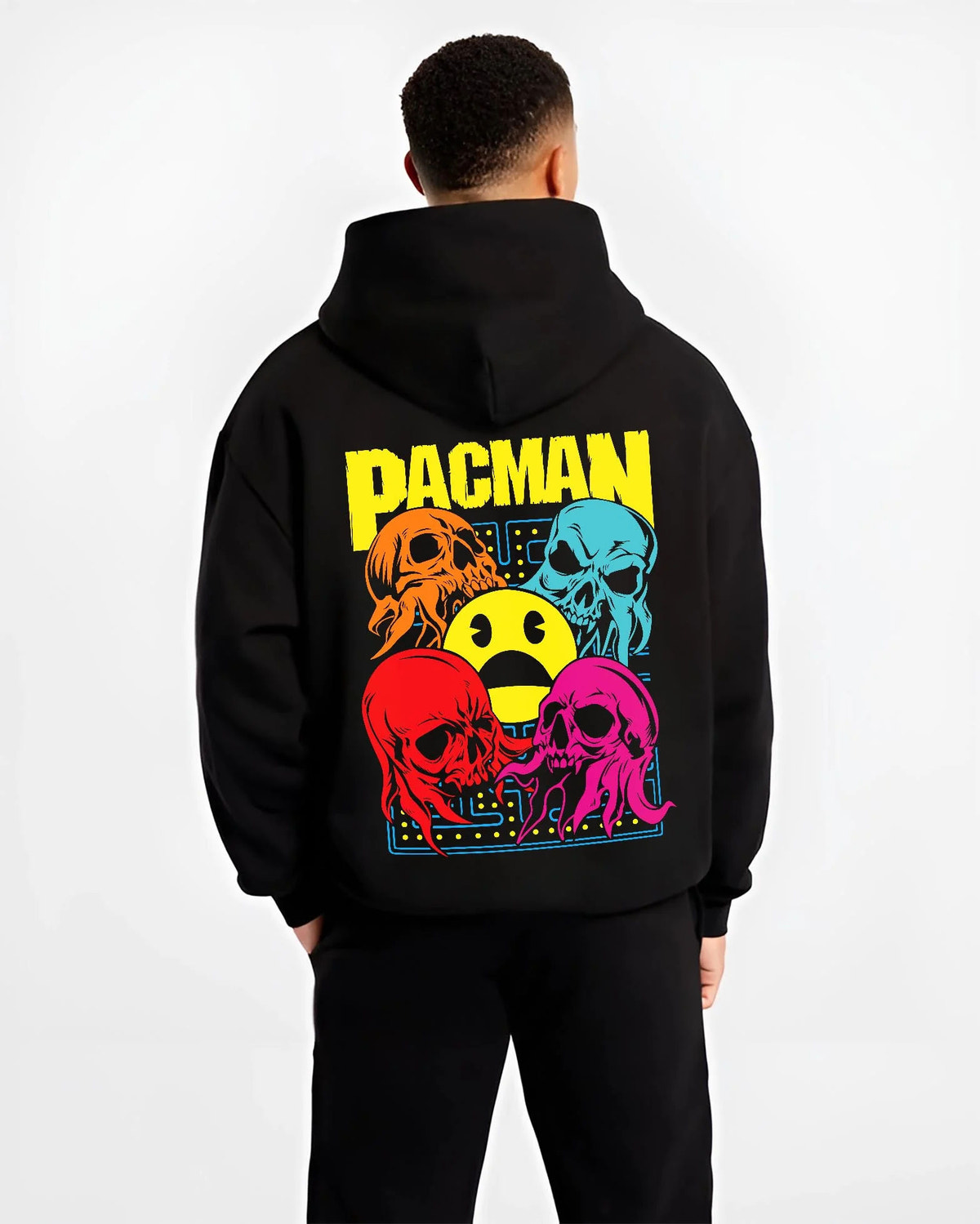 Black hoodie worn by male model from the back featuring Pac-Man ghost chase arcade Pac-Man artwork.