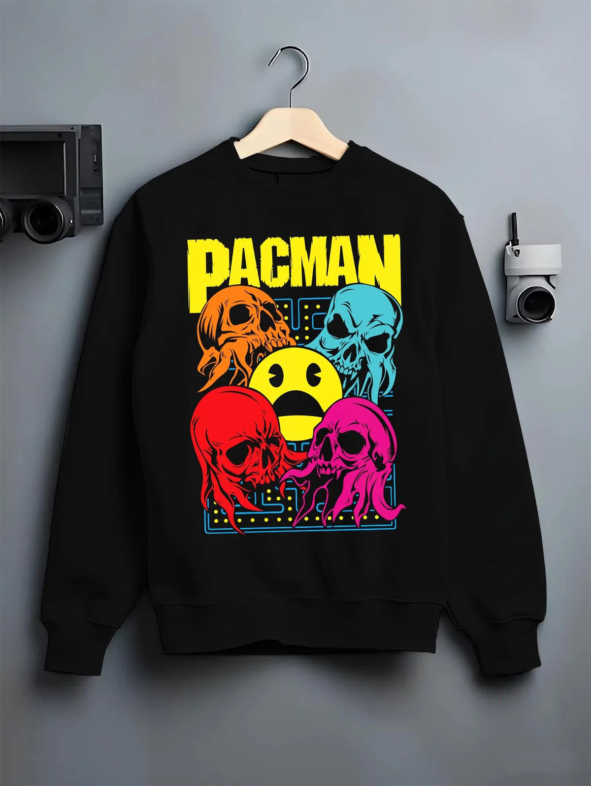 Black crewneck sweatshirt on hanger featuring Pac-Man ghost chase arcade Pac-Man artwork.