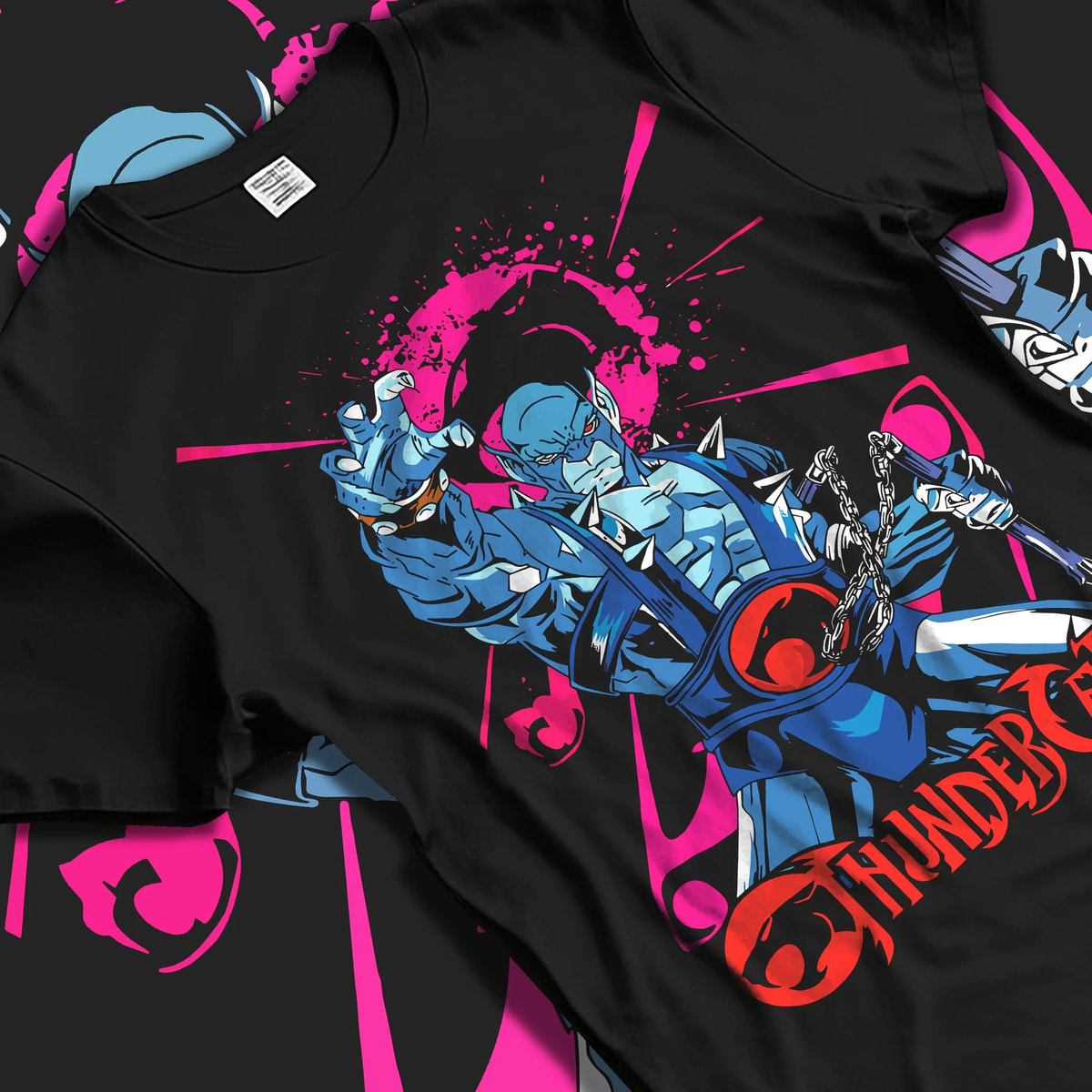 Black T-shirt laid flat with natural folds featuring Panthro nunchaku warrior ThunderCats artwork.