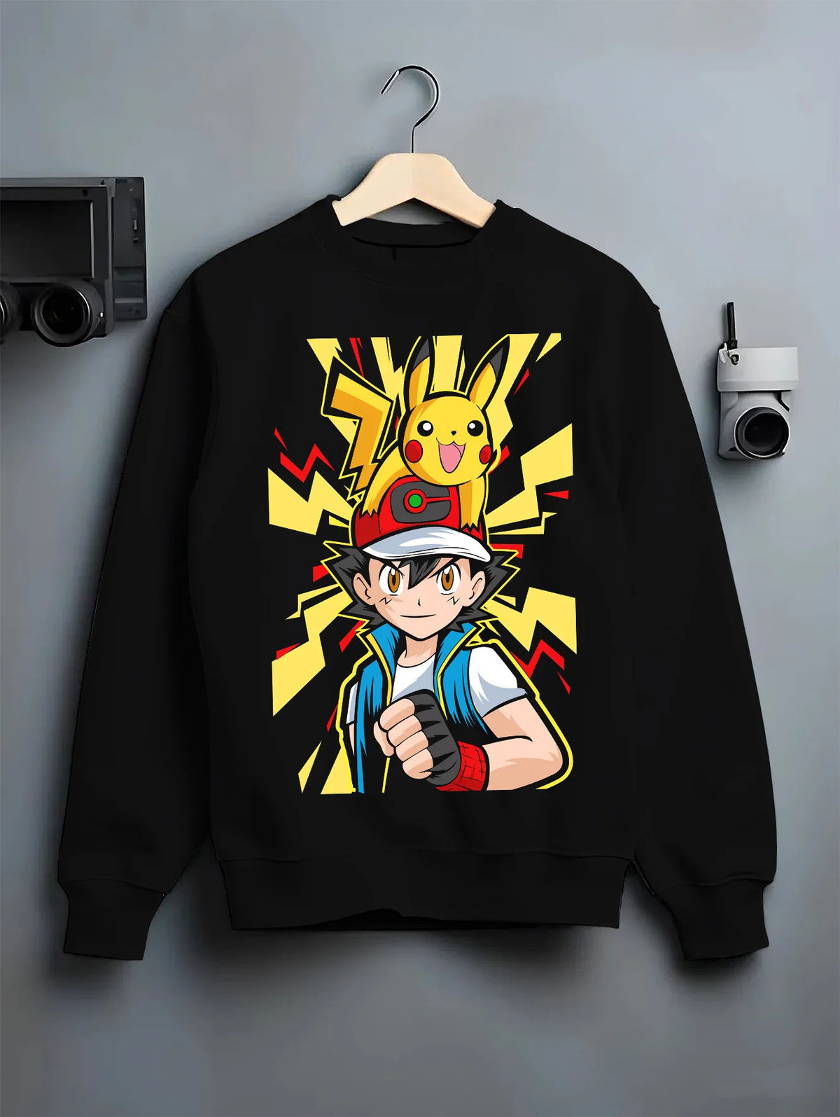 Black crewneck sweatshirt on hanger with Ash / Red with yellow Pikachu lightning design from Pokémon illustrated back graphic