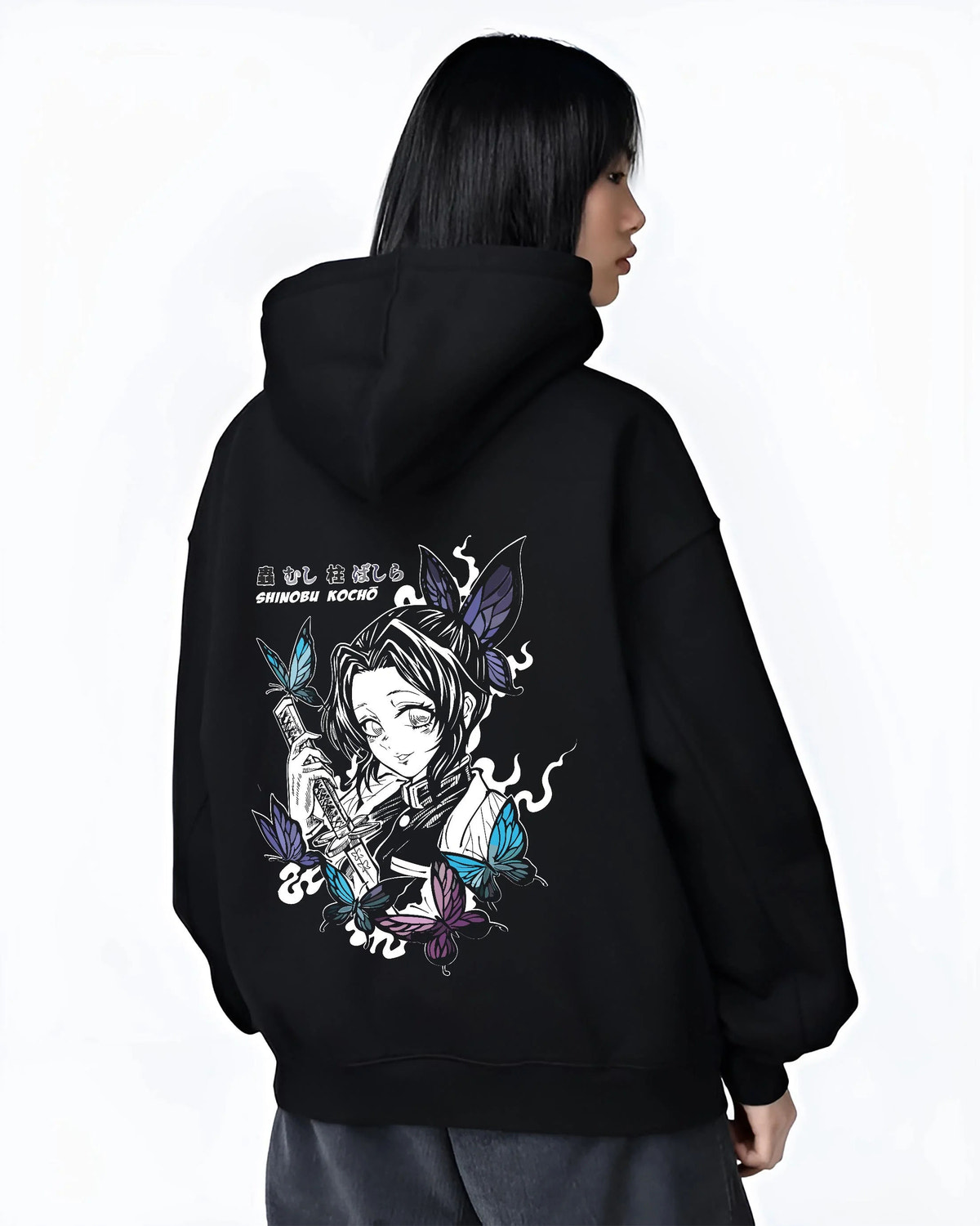 Black hoodie worn by female model from the back featuring Shinobu Kocho poison butterfly Demon Slayer artwork.