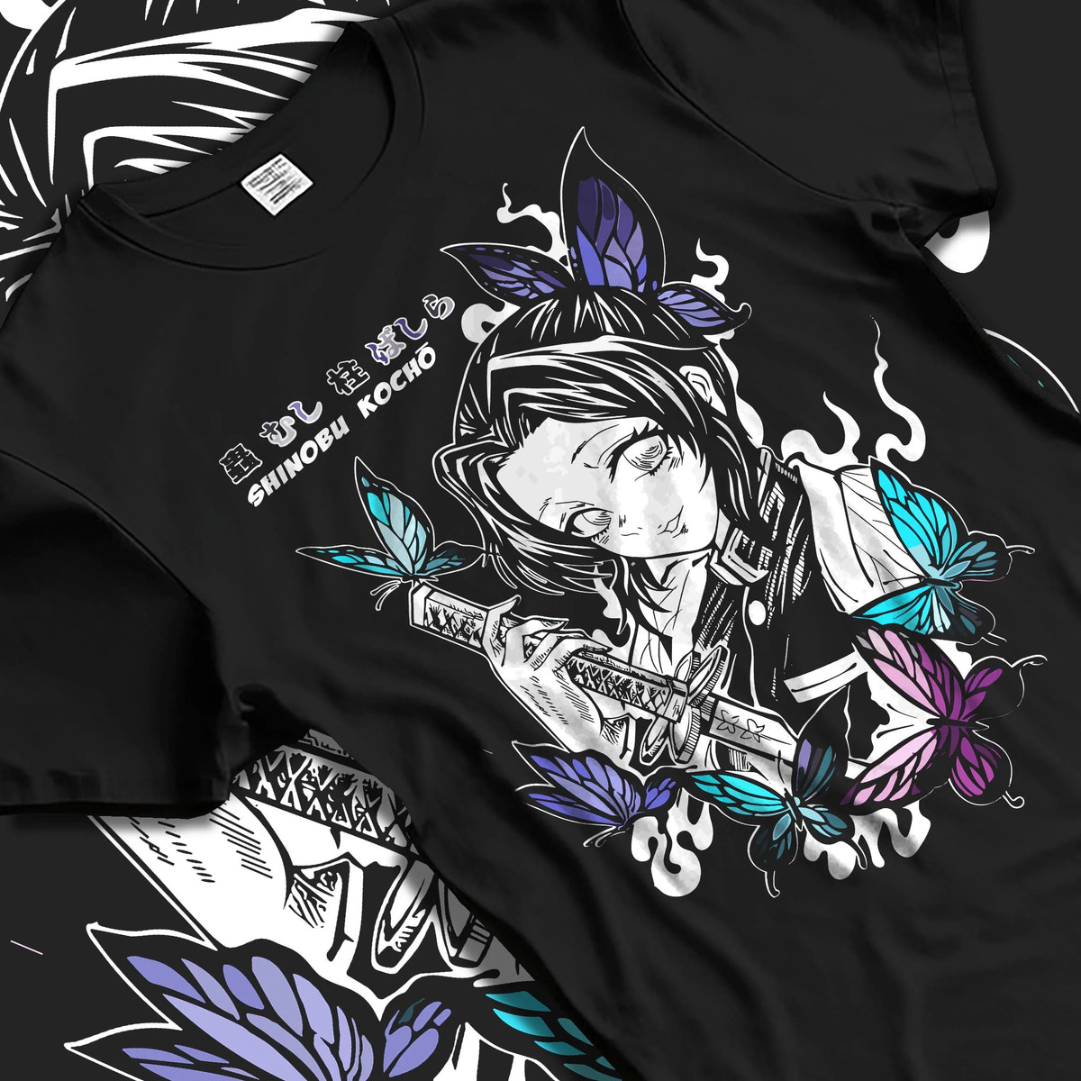 Black T-shirt laid flat with natural folds featuring Shinobu Kocho poison butterfly Demon Slayer artwork.