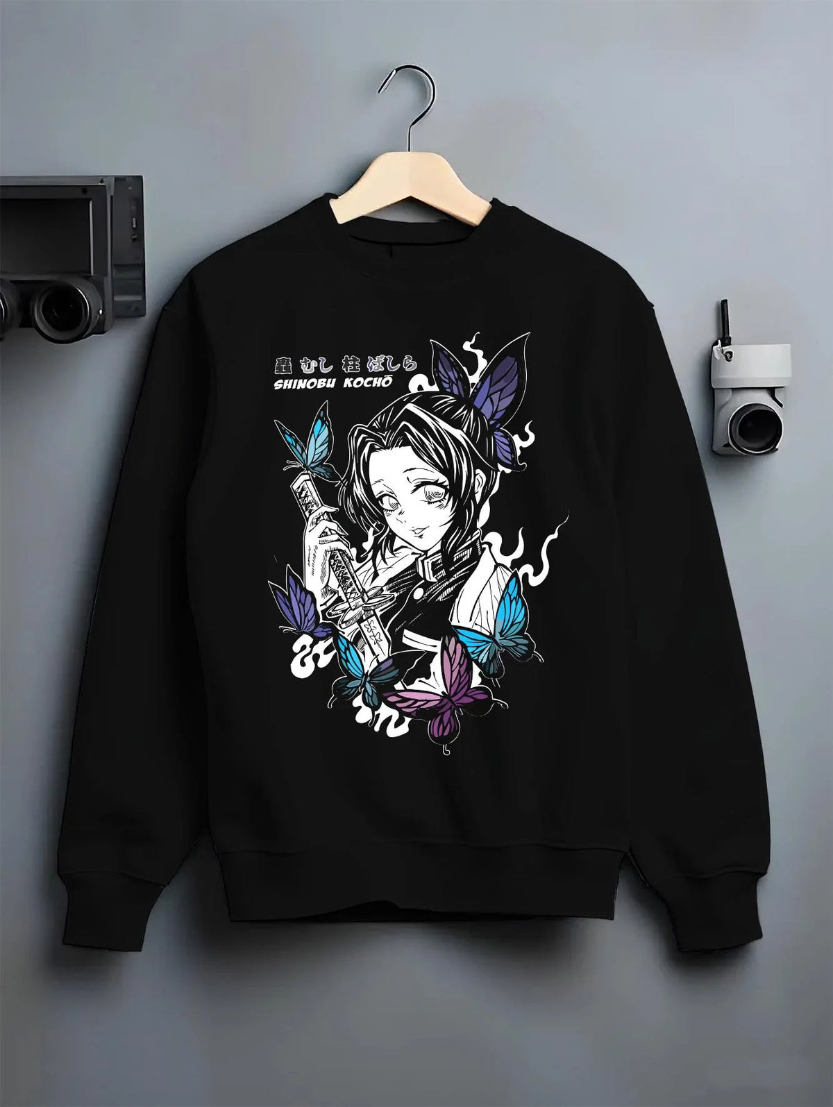 Black crewneck sweatshirt on hanger featuring Shinobu Kocho poison butterfly Demon Slayer artwork.