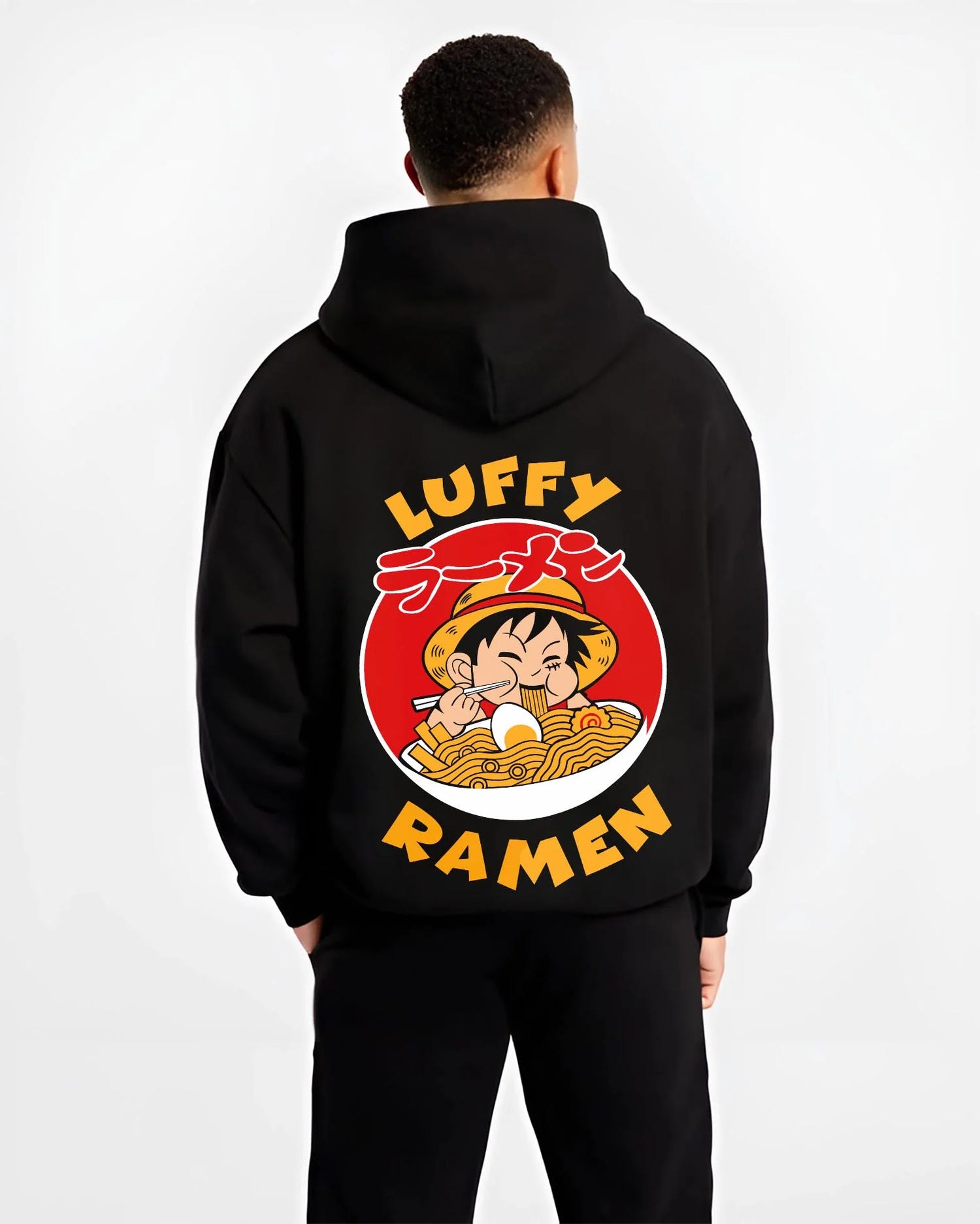 Black hoodie worn by male model, back view with Luffy Ramen Hoodie One Piece Pirate Food Design graphic premium wear.