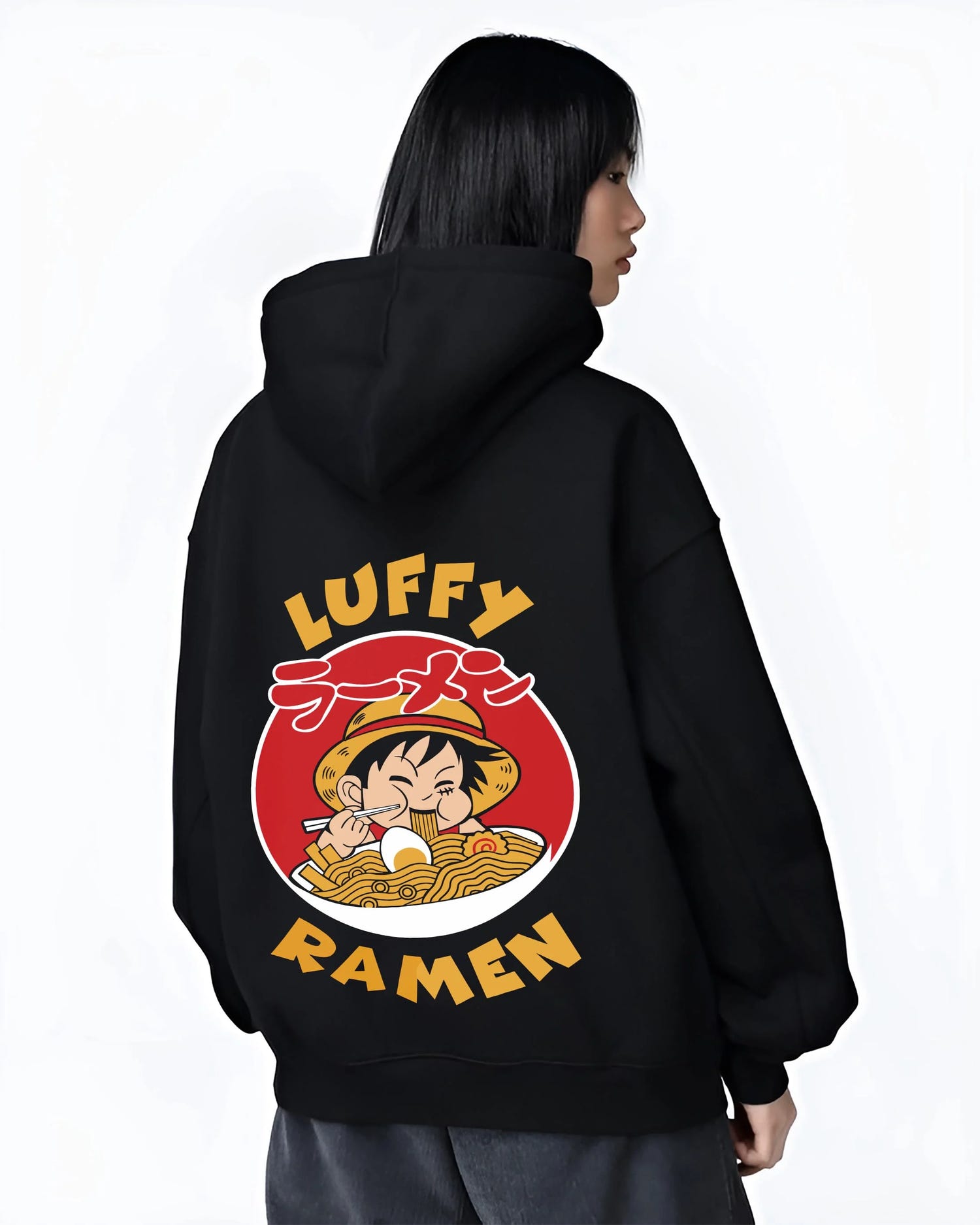 Black hoodie worn by female model, back view with Luffy Ramen Hoodie One Piece Pirate Food Design graphic streetwear graphic.