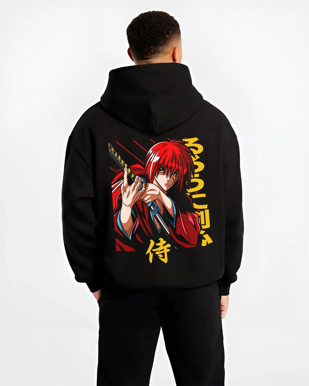 Black hoodie worn by male model from the back featuring Kenshin Himura samurai sword Rurouni Kenshin artwork.