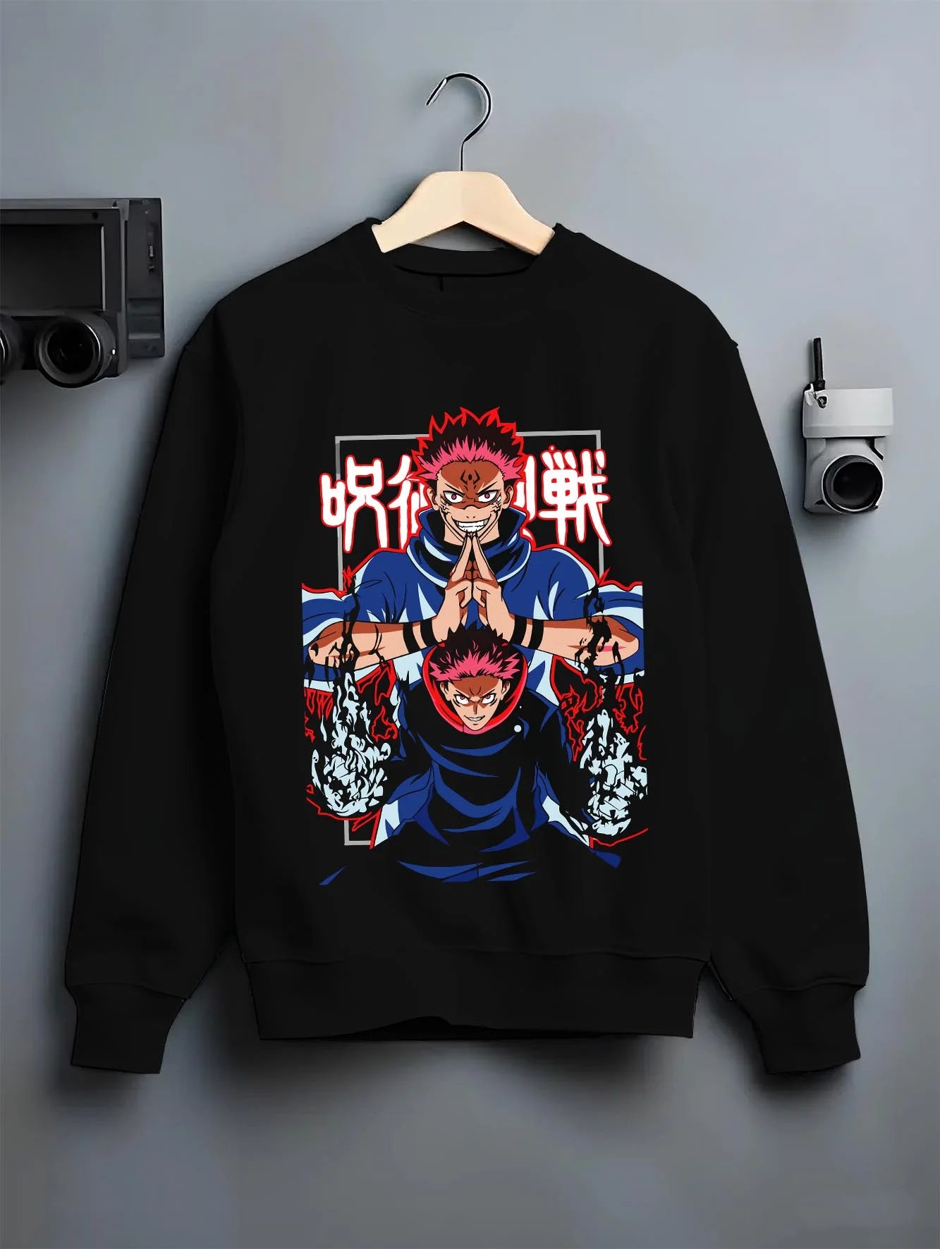 Black crewneck sweatshirt on hanger with Yuji Itadori Hoodie Jujutsu Kaisen Action Pose graphic bold anime graphic.