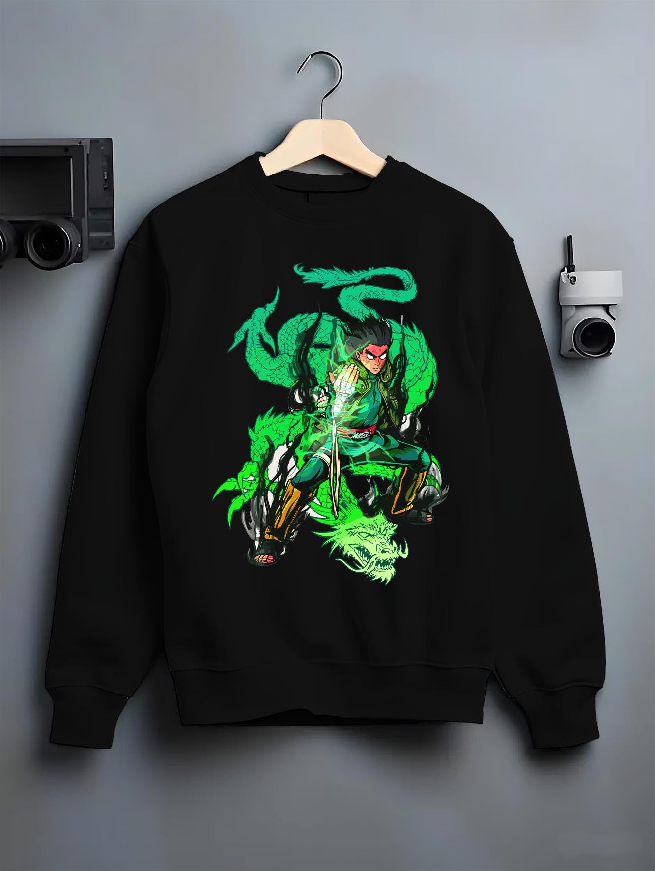 Black crewneck sweatshirt on a hanger against a grey wall, featuring Dragon Ball Gohan anime poster inspired design with Shenron dragon aura in glowing retro manga battle style.