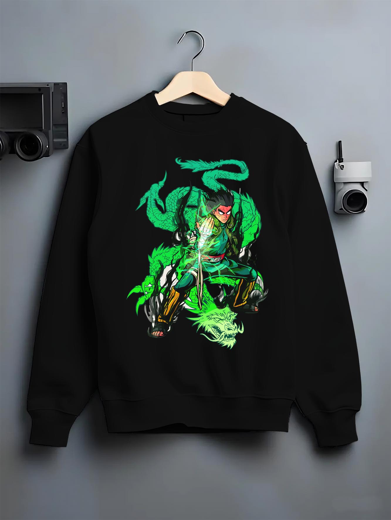 Black crewneck sweatshirt on a hanger against a grey wall, featuring Dragon Ball Gohan anime poster inspired design with Shenron dragon aura in glowing retro manga battle style.