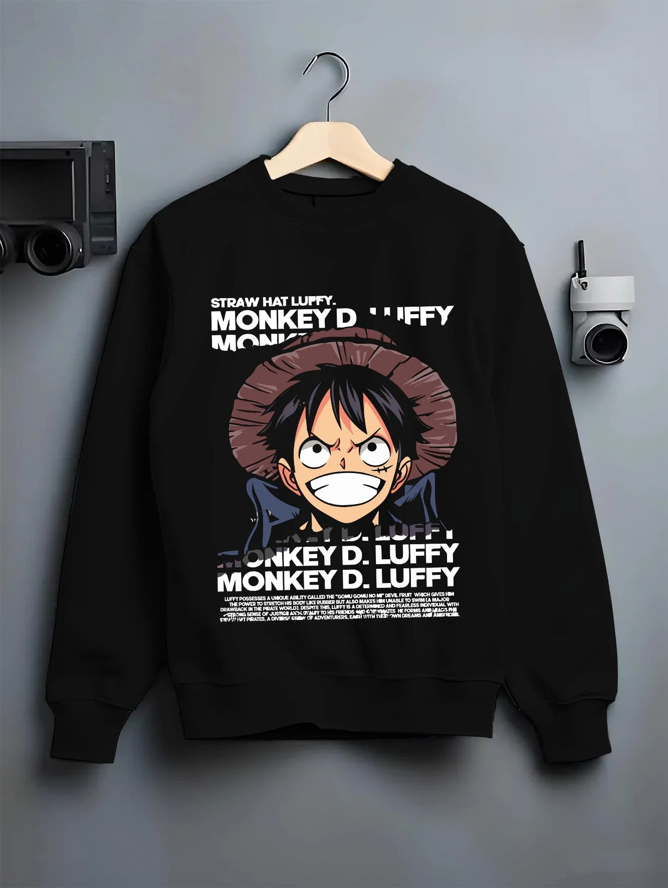 Black crewneck sweatshirt on hanger with Monkey D Luffy Hoodie One Piece Pirate King graphic bold anime graphic.