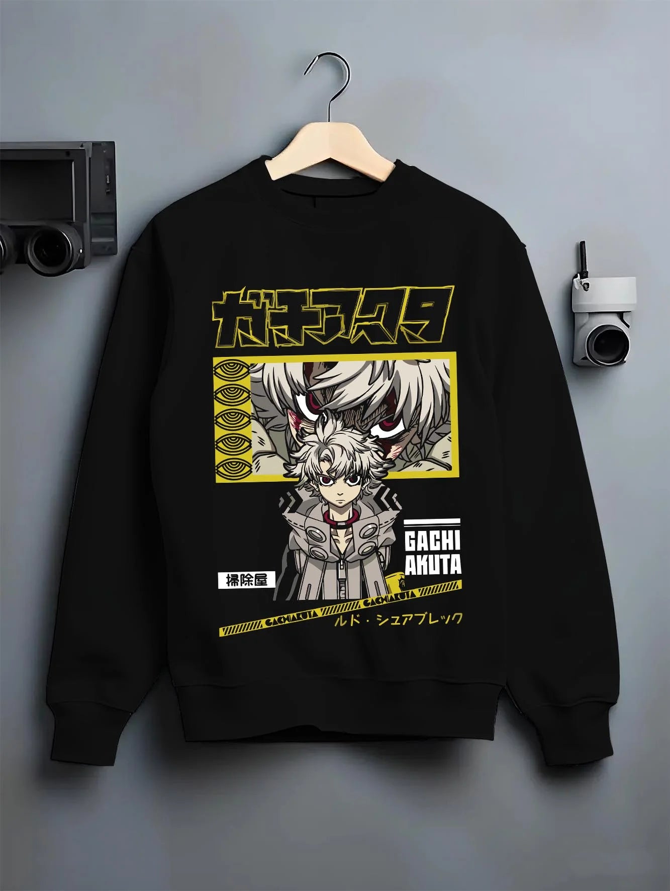 Black crewneck sweatshirt on hanger with Rudo Hoodie Gachiakuta Character Action Scene graphic premium wear.