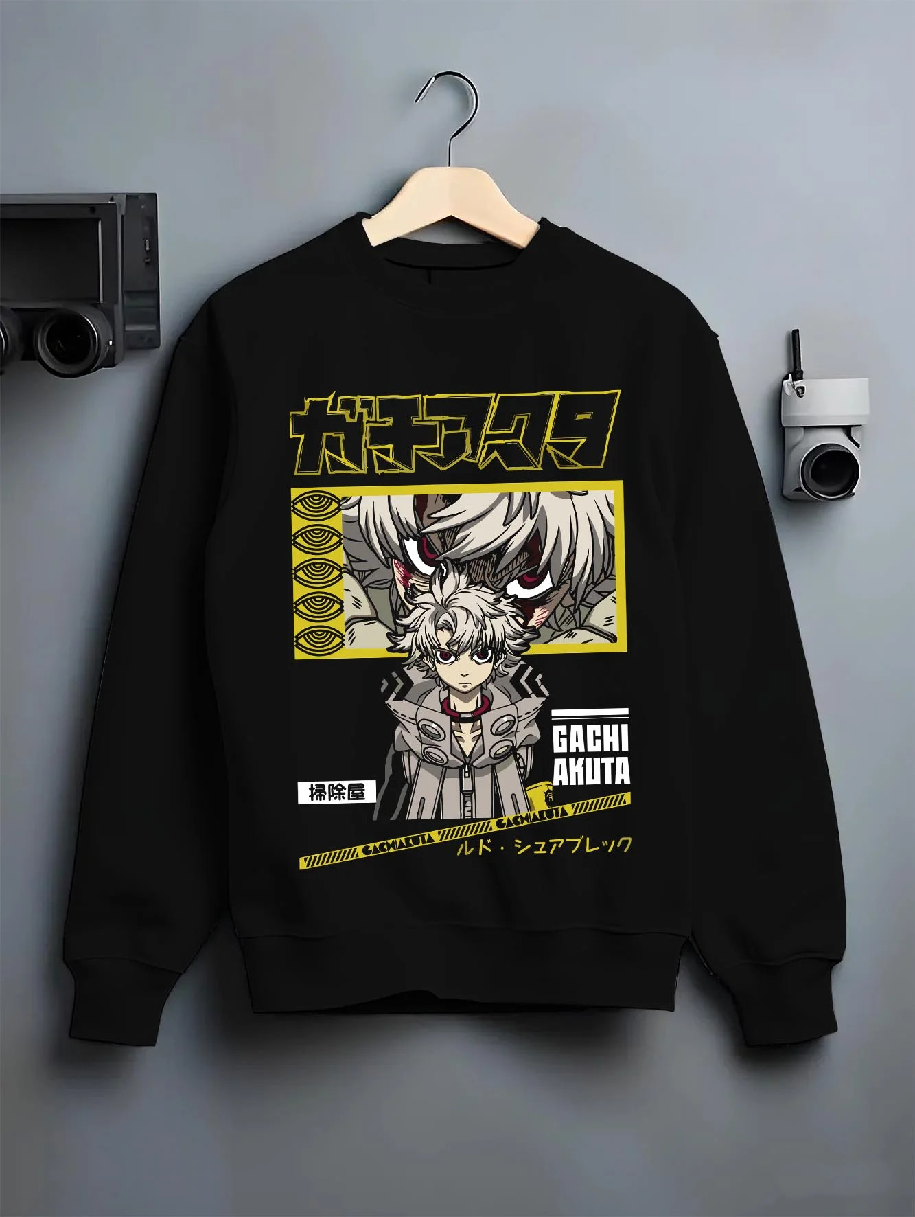 Black crewneck sweatshirt on hanger with Rudo Hoodie Gachiakuta Character Action Scene graphic premium wear.