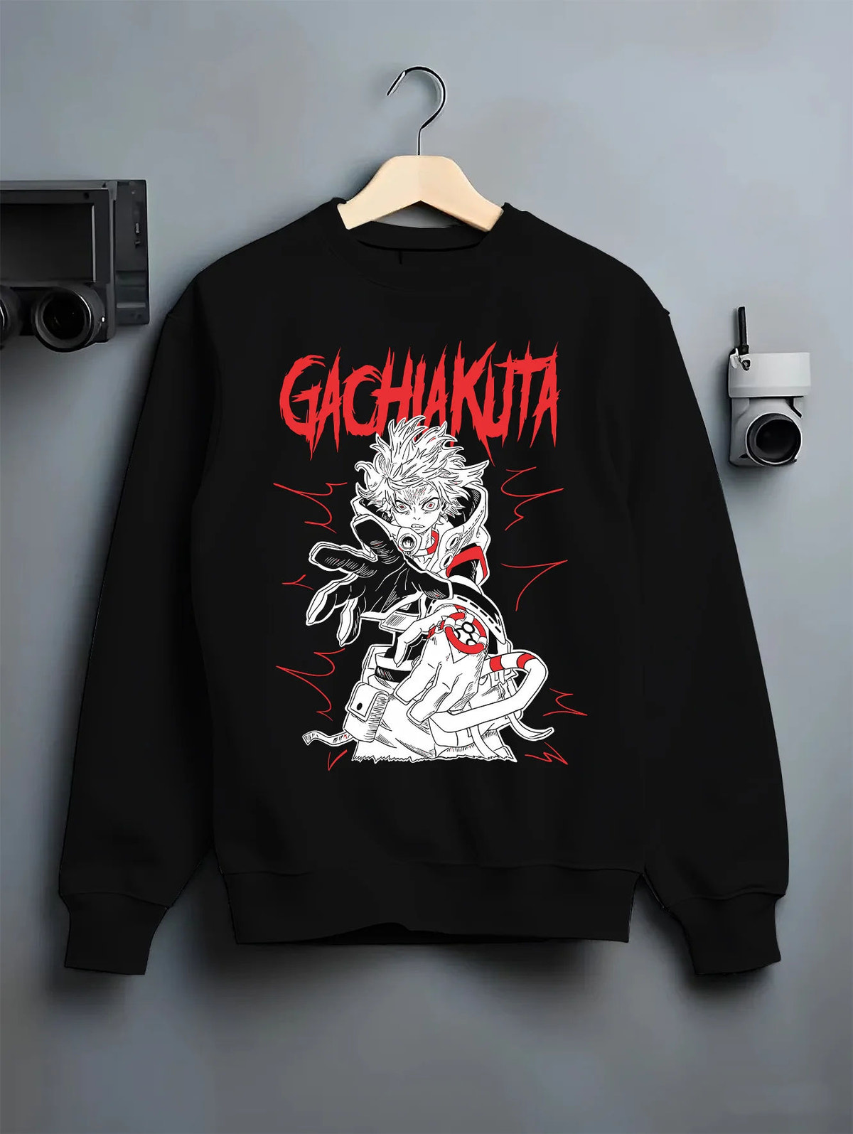 Black crewneck sweatshirt on hanger showing Rudo Surebrec from Gachiakuta: red-and-black design