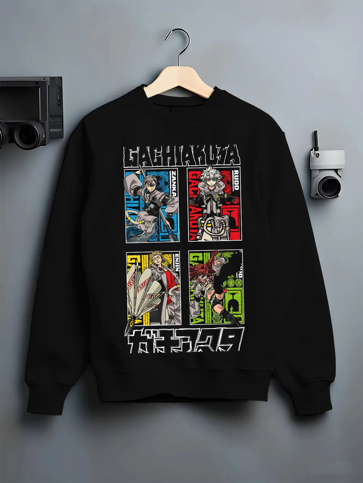 Black crewneck sweatshirt on hanger with Rudo, Zanka, Enjin and Gachiakuta cast illustrated back graphic