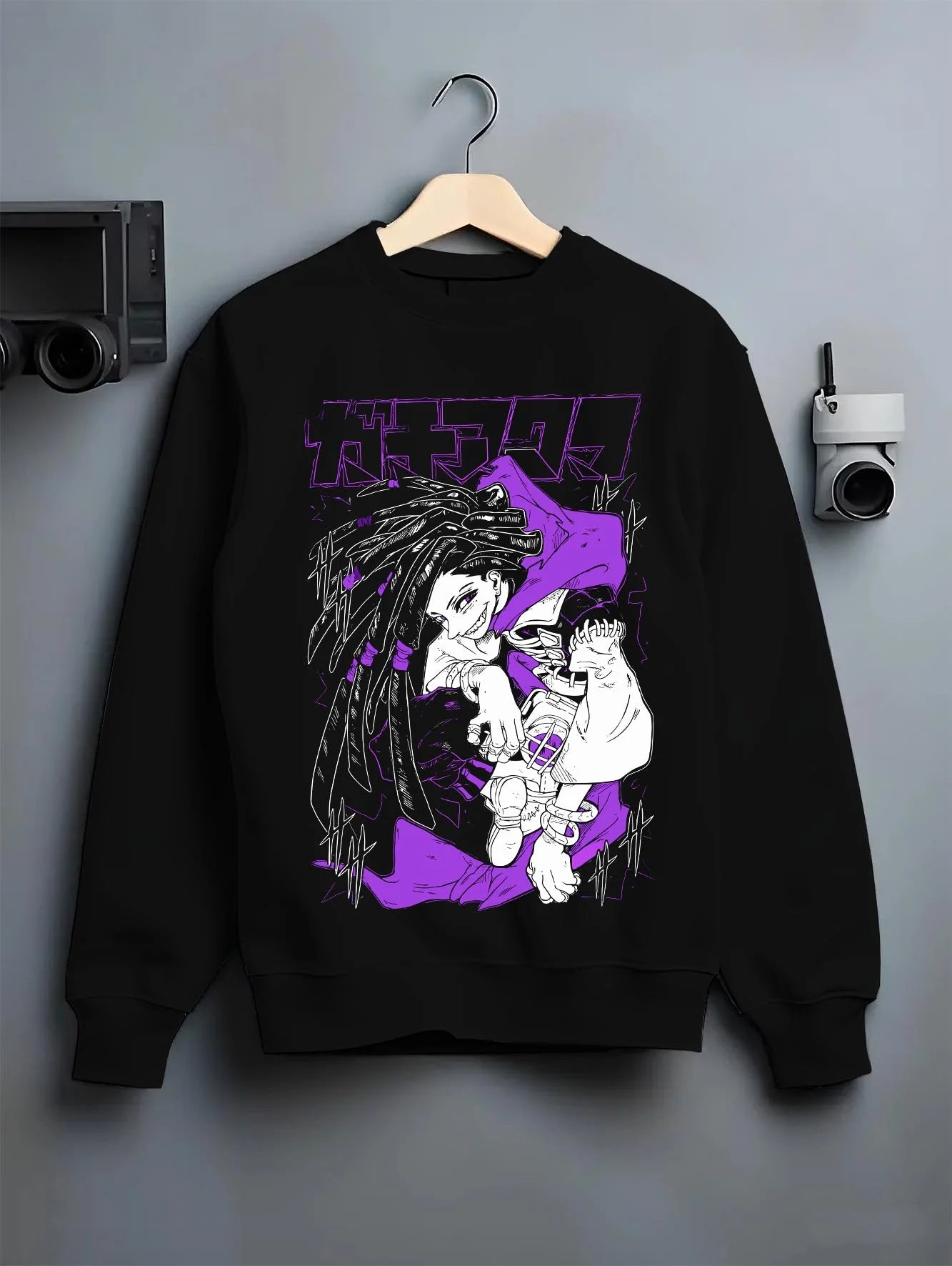 Black crewneck sweatshirt on hanger with Rudo Hoodie Gachiakuta Purple Dreadlock Form graphic bold anime graphic.