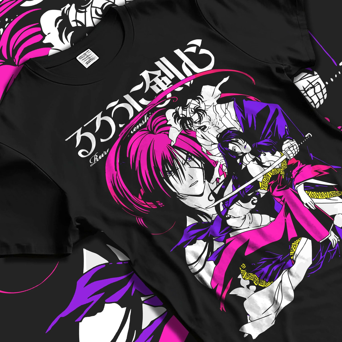 Black T-shirt laid flat with natural folds featuring Kenshin Himura reverse blade sword Rurouni Kenshin artwork.