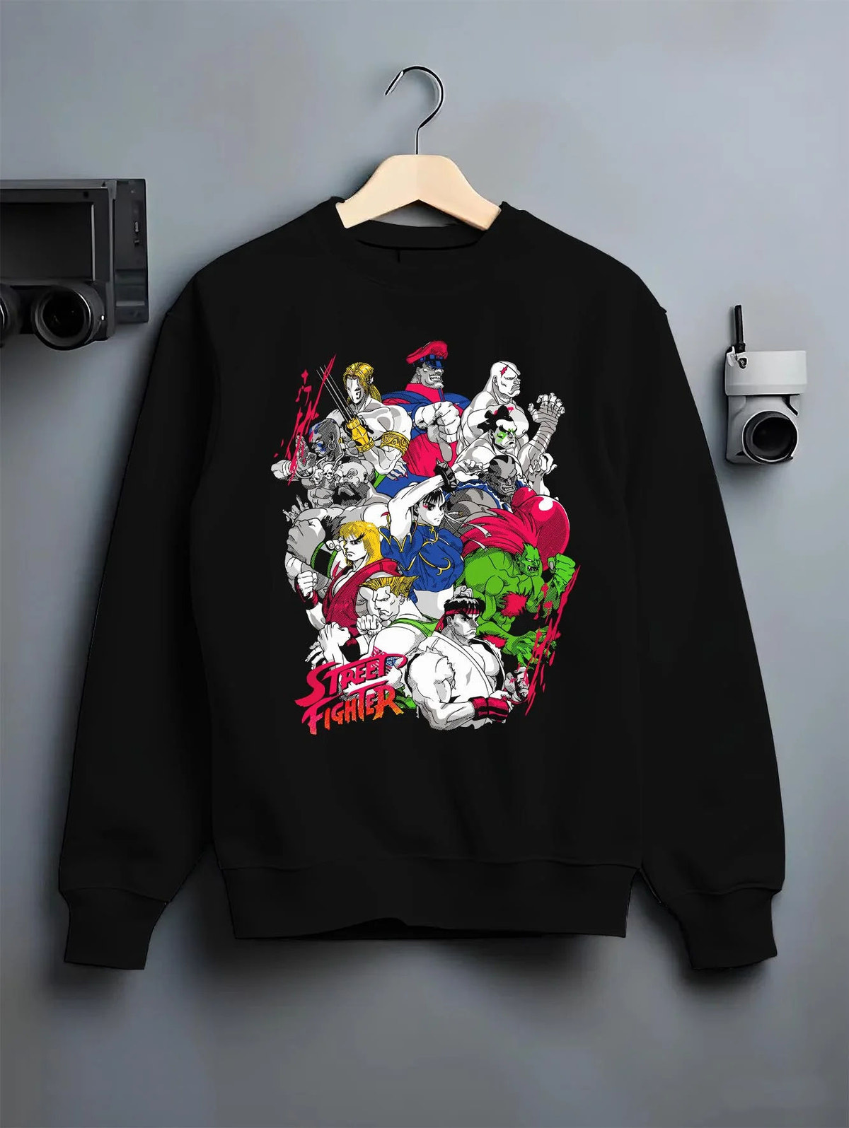 Black crewneck sweatshirt on hanger featuring Ryu Hadouken World Warrior Street Fighter artwork.