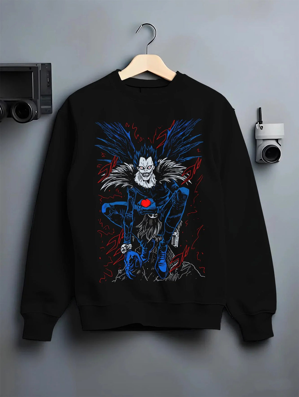 Black crewneck sweatshirt on hanger featuring Ryuk Shinigami apple Death Note artwork.