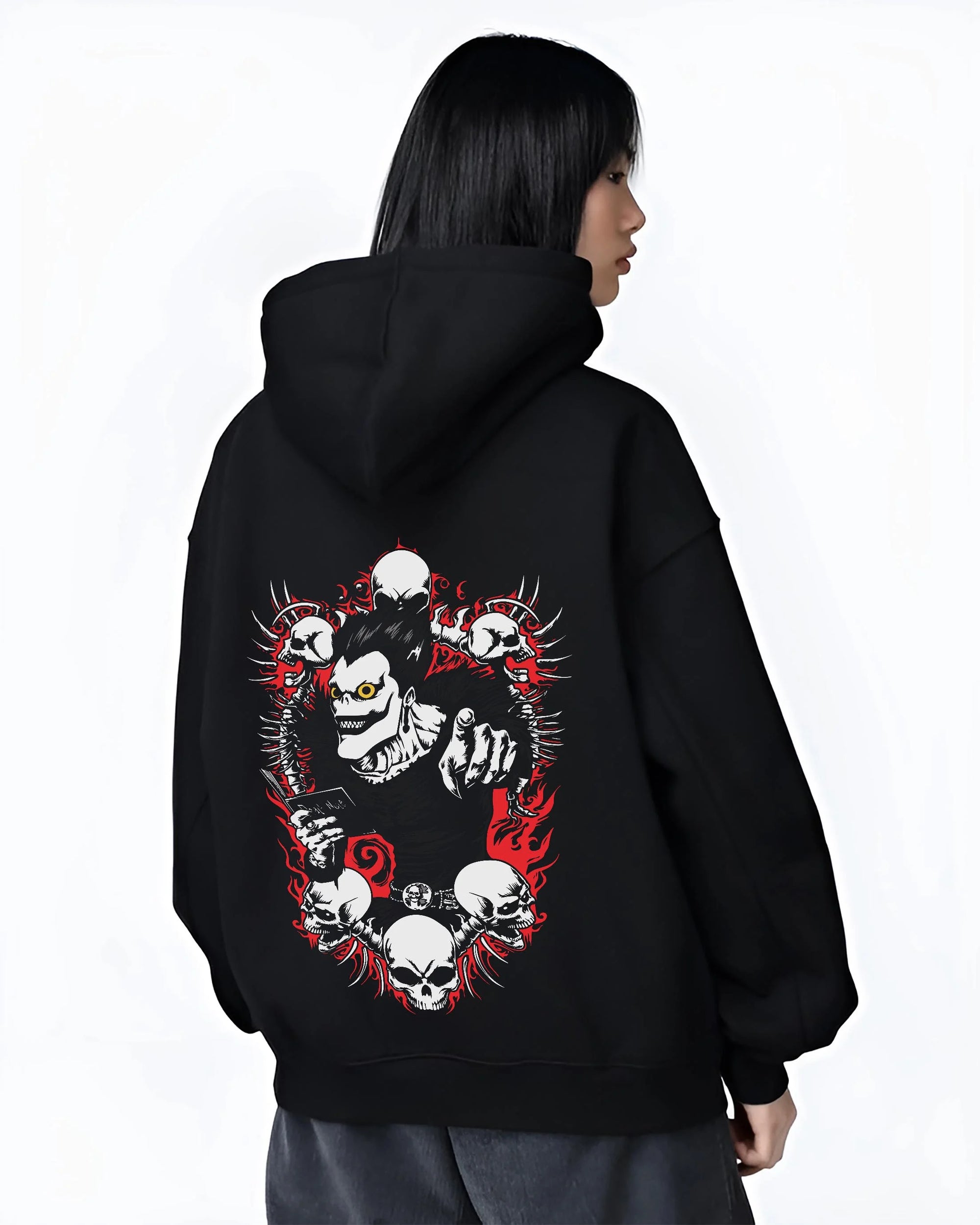 Black hoodie worn by female model, back view with Ryuk Hoodie Death Note Shinigami Apple Reaper Anime graphic Ryuk themed artwork.
