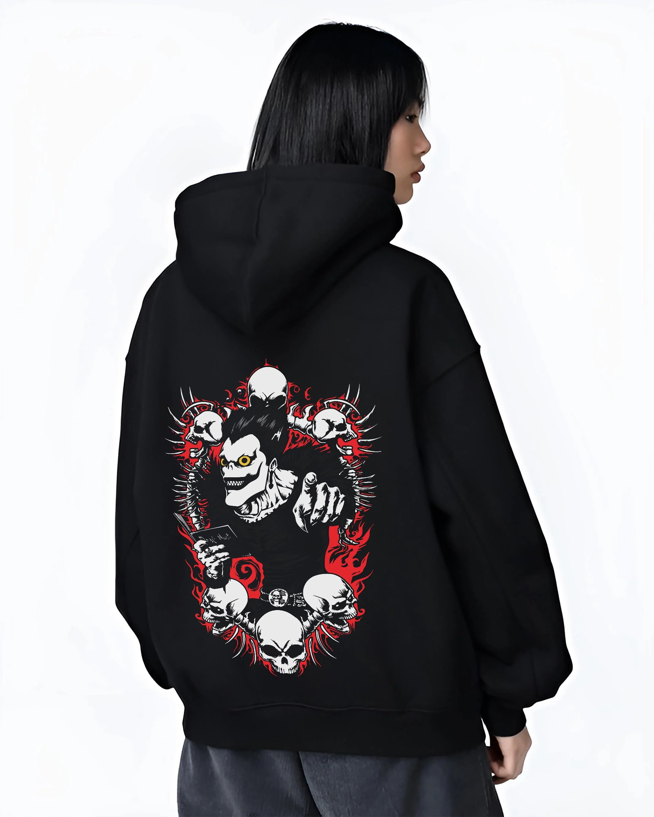 Black hoodie worn by female model, back view with Ryuk Hoodie Death Note Shinigami Apple Reaper Anime graphic Ryuk themed artwork.