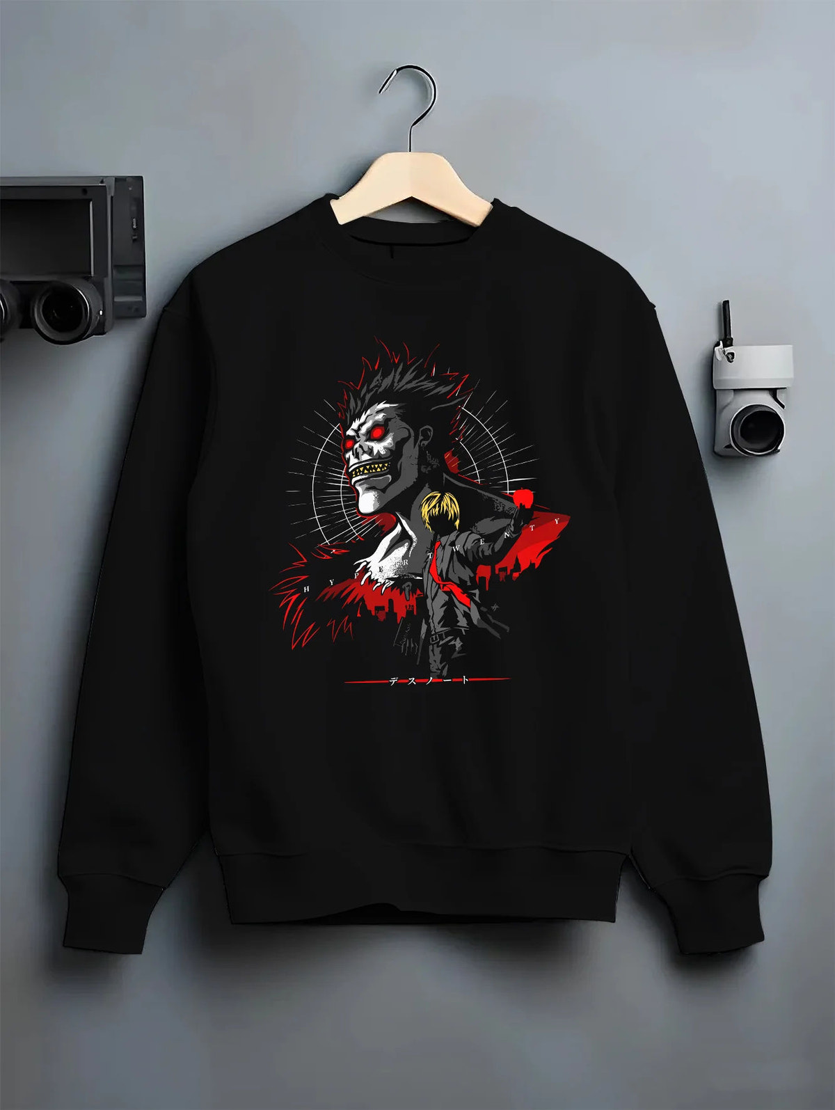 Black crewneck sweatshirt on hanger showing Ryuk from Death Note: Shinigami red-black lighting design