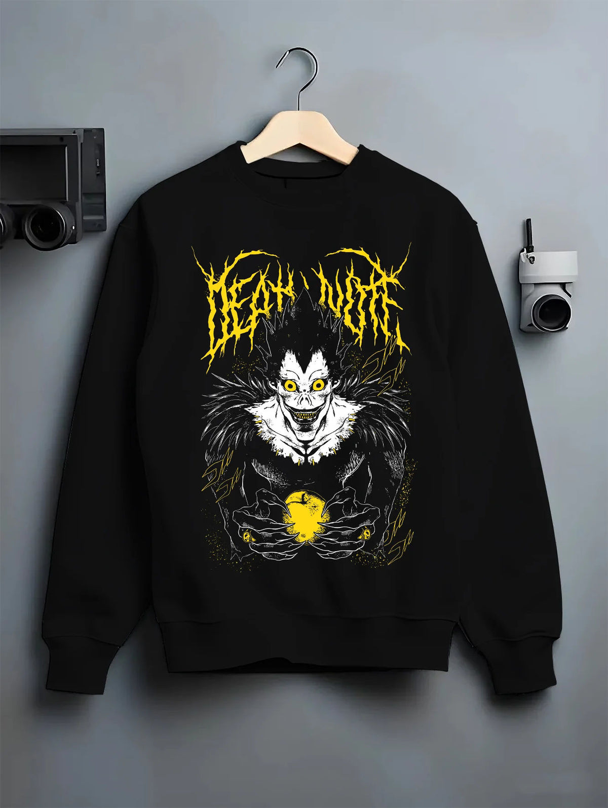 Black crewneck sweatshirt on hanger showing Ryuk from Death Note: Shinigami with apple