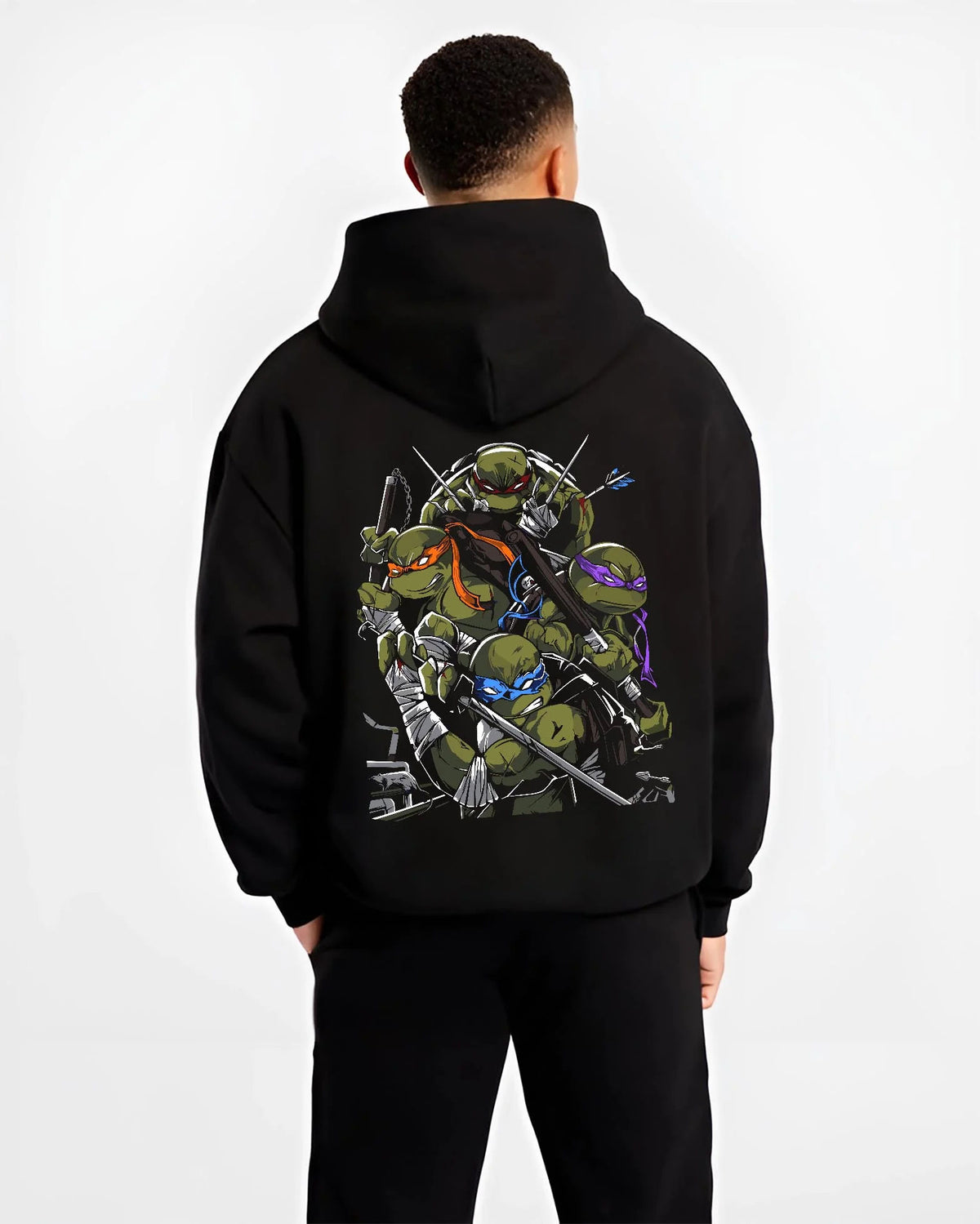 Black hoodie worn by male model from the back featuring Teenage Mutant Ninja Turtles sewer team TMNT artwork.