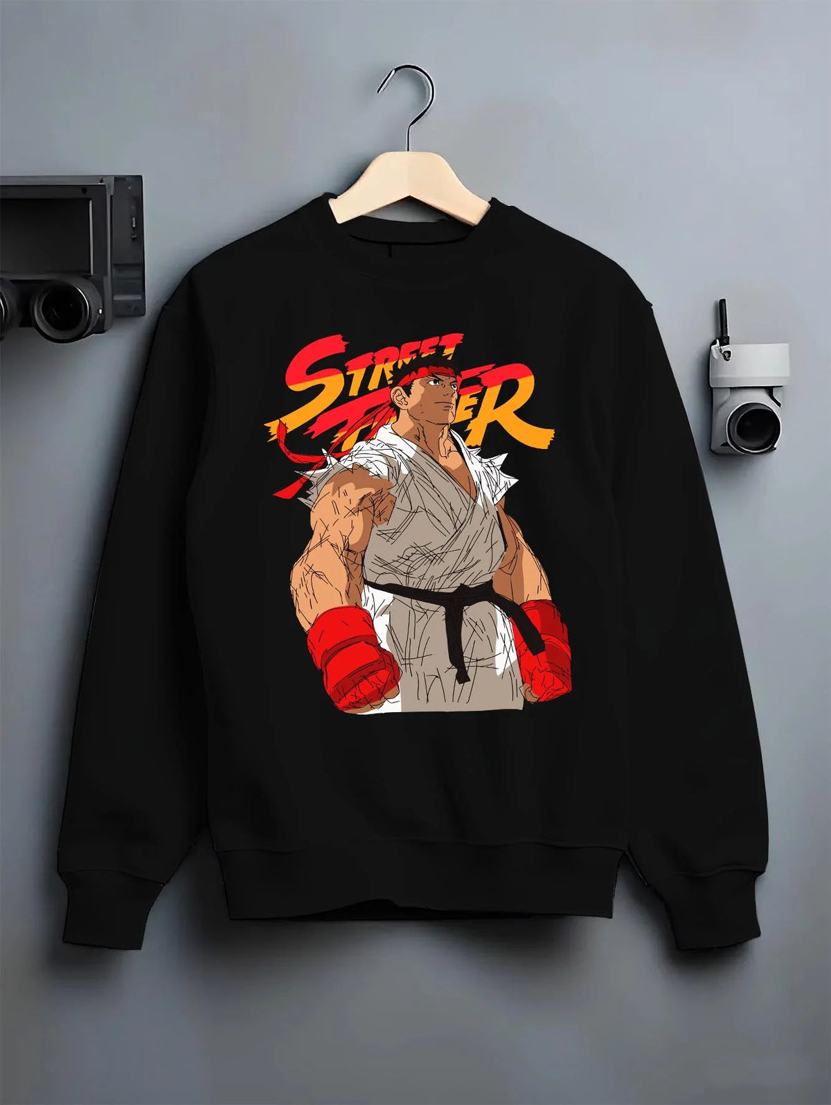 Black crewneck sweatshirt on hanger featuring Ryu Shoryuken World Warrior Street Fighter artwork.