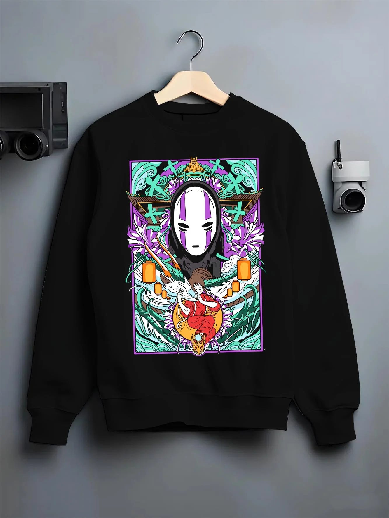 Black crewneck sweatshirt on hanger with Spirited Away Hoodie No Face Bathhouse Anime Miyazaki graphic streetwear graphic.