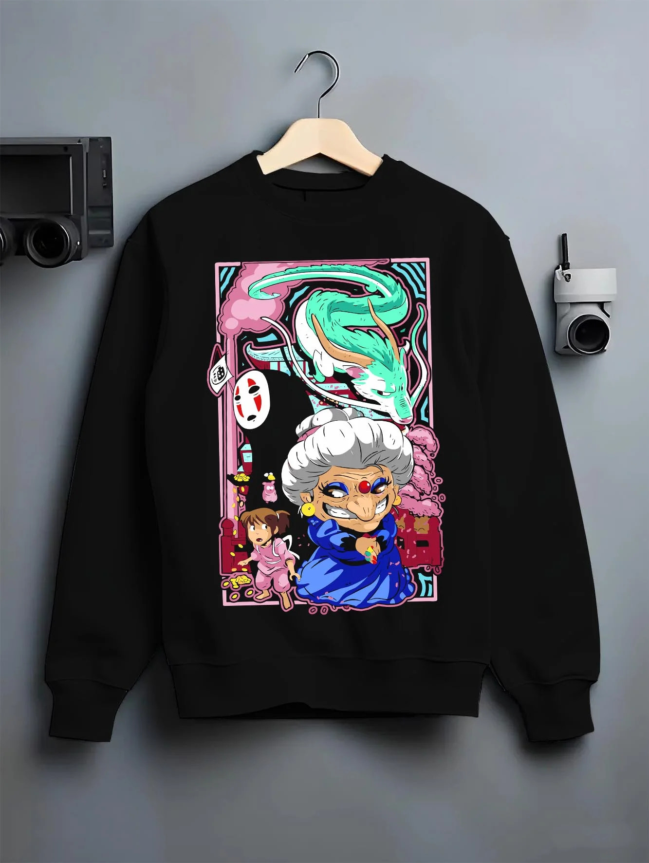 Black crewneck sweatshirt on hanger with Spirited Away Hoodie Yubaba Boh Soot Sprite Anime graphic premium wear.