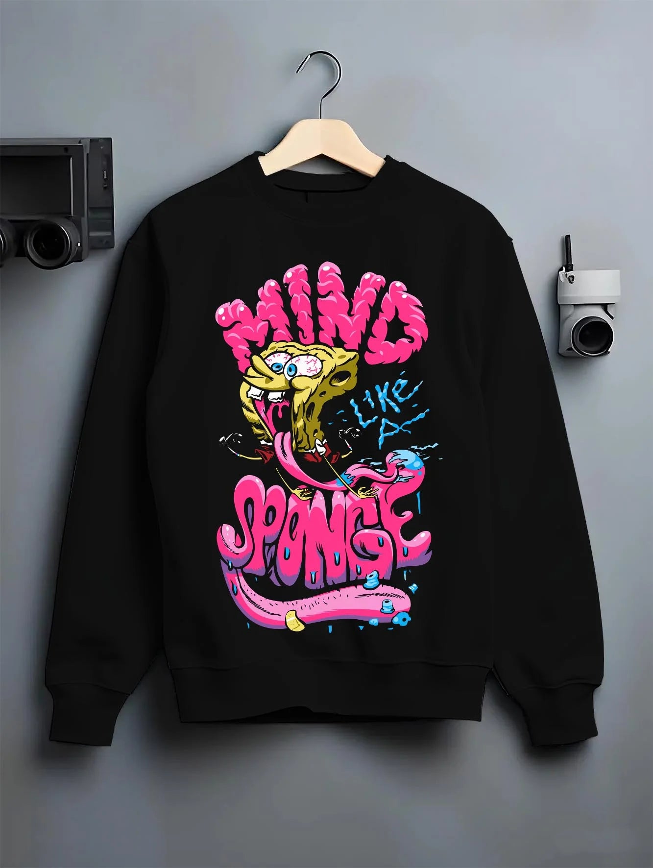Black crewneck sweatshirt on hanger with SpongeBob Hoodie Mind Sponge Cartoon Retro Parody graphic streetwear graphic.