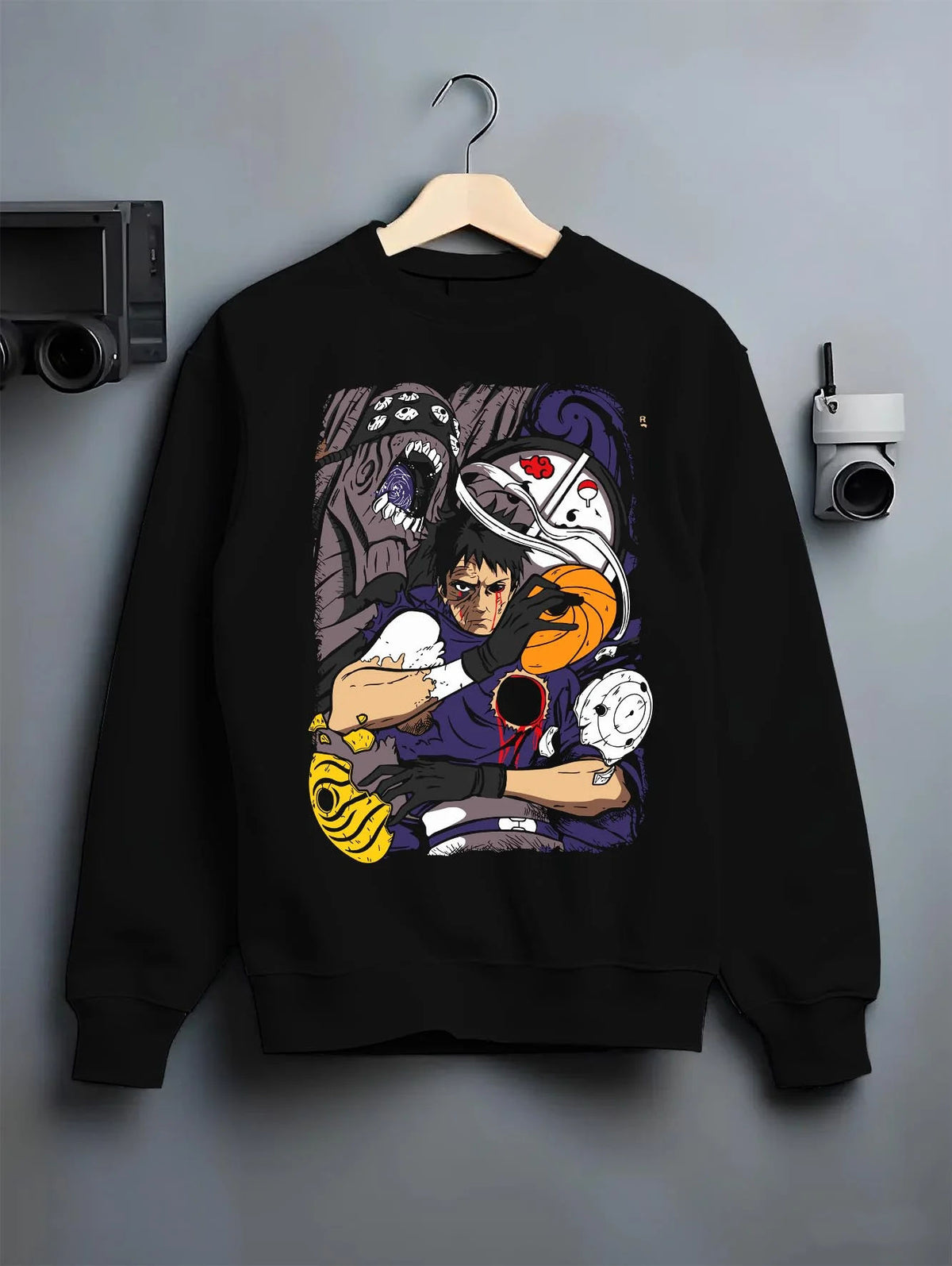 Black crewneck sweatshirt on hanger featuring Obito Uchiha Tobi spiral masks Naruto artwork.
