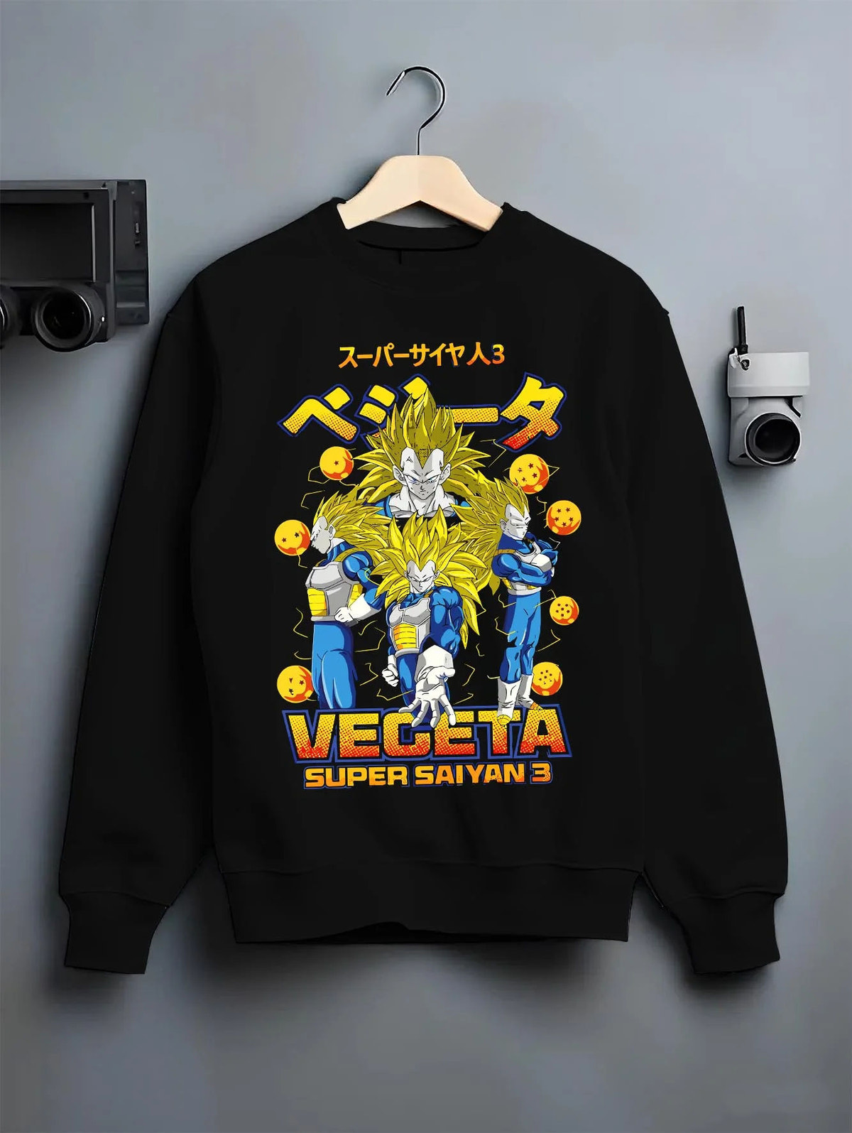 Black crewneck sweatshirt on hanger featuring Vegeta Super Saiyan 3 golden power Dragon Ball artwork.