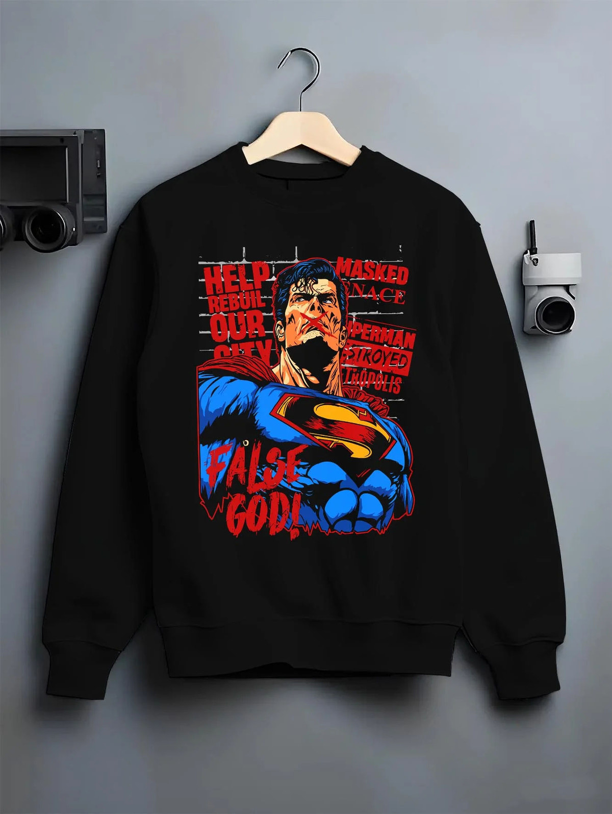 Black crewneck sweatshirt on hanger featuring Superman False God Man of Steel DC Comics artwork.