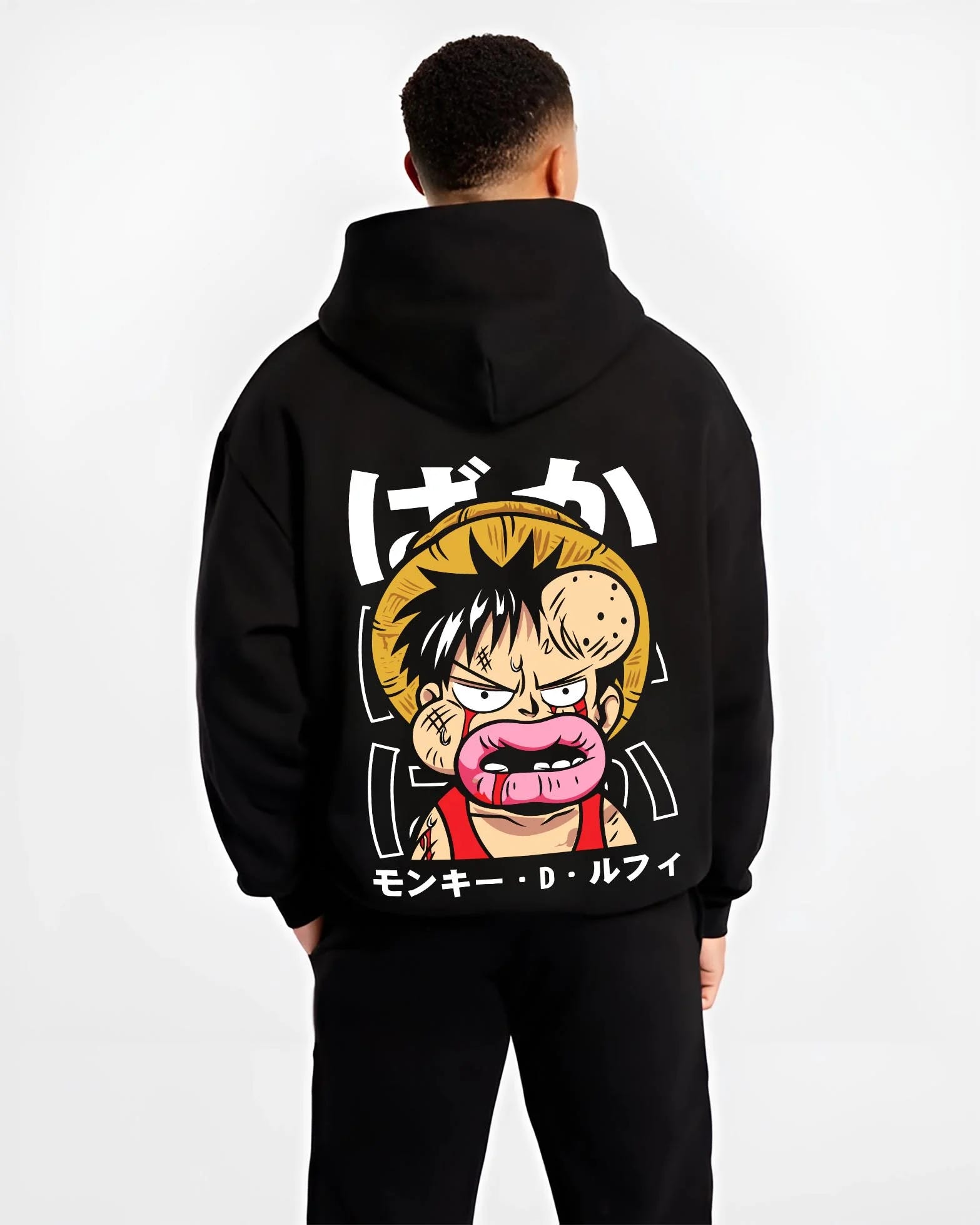 Black hoodie worn by male model, back view with Monkey D Luffy Hoodie One Piece Funny Face graphic premium wear.
