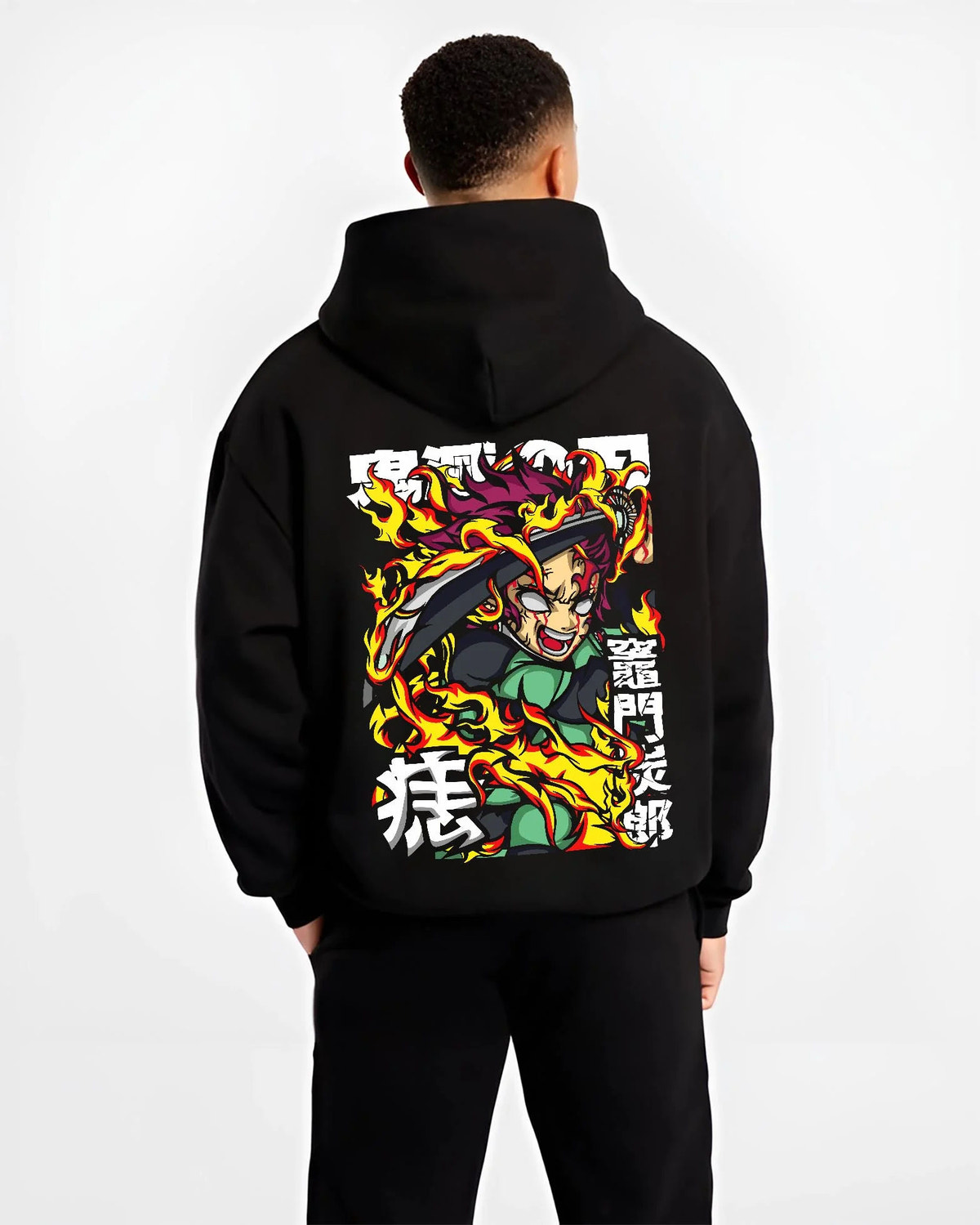 Black hoodie worn by male model from the back featuring Yoriichi Tsugikuni Sun Breathing flame aura Demon Slayer artwork.