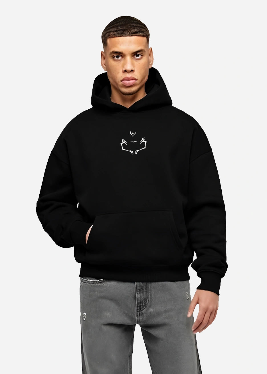 Male model wearing black Sukuna symbol hoodie from Jujutsu Kaisen anime, minimalist cursed mark design by Kunai anime streetwear collection.