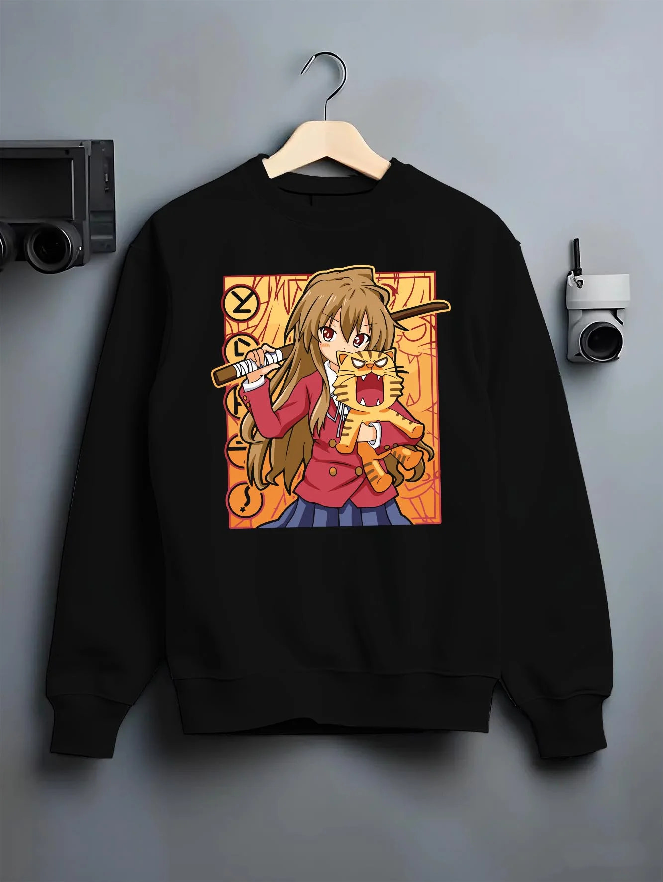 Black crewneck sweatshirt on hanger with Taiga Hoodie Toradora Anime Tiger Romantic Comedy graphic premium wear.