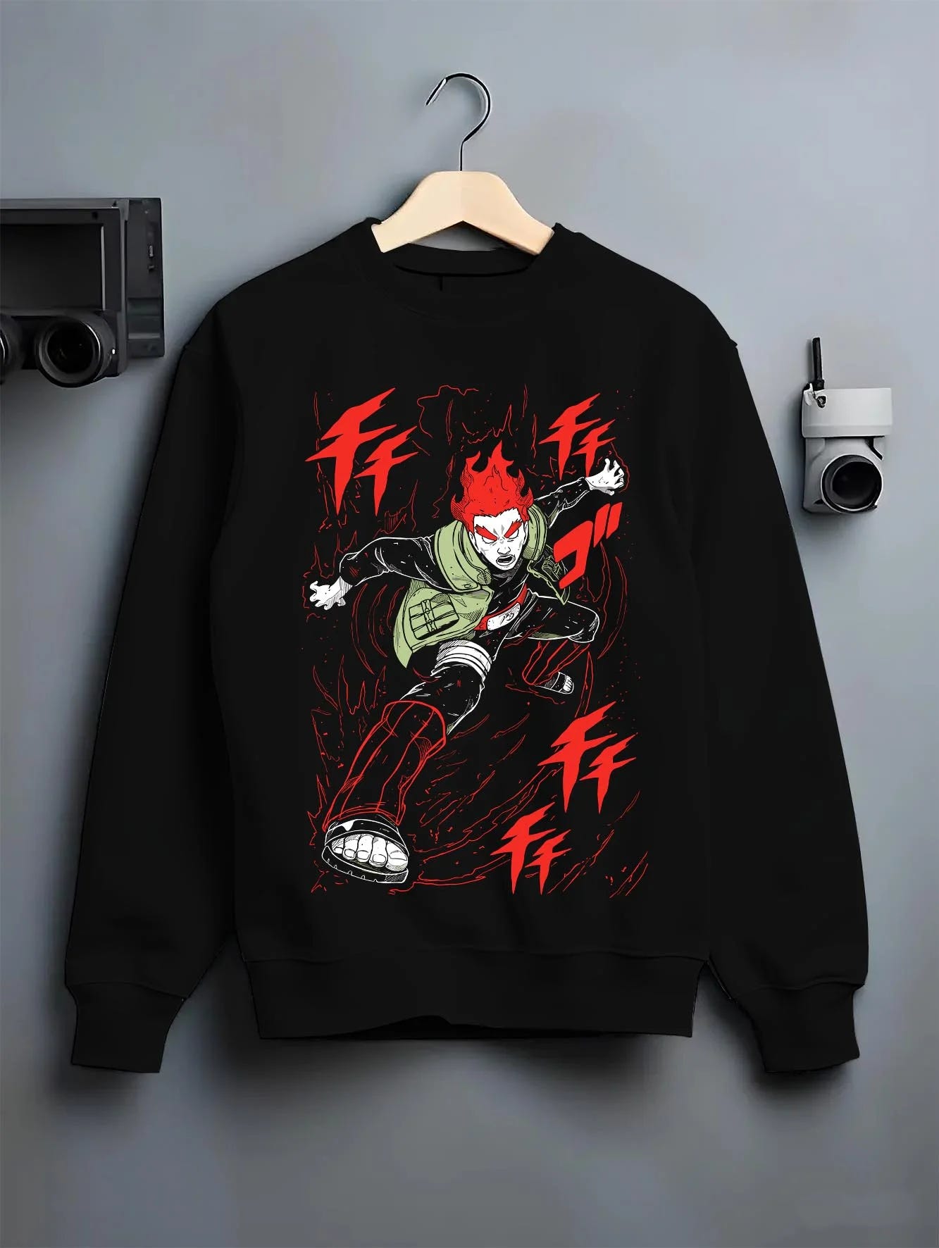 Black crewneck sweatshirt on hanger with Might Guy Hoodie Naruto Dynamic Entry Flames graphic bold anime graphic.