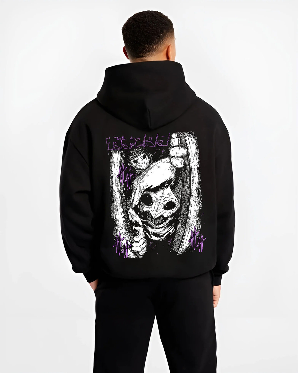 Black hoodie model back view showing Tamsy from Gachiakuta: eerie close-up mask/pupil
