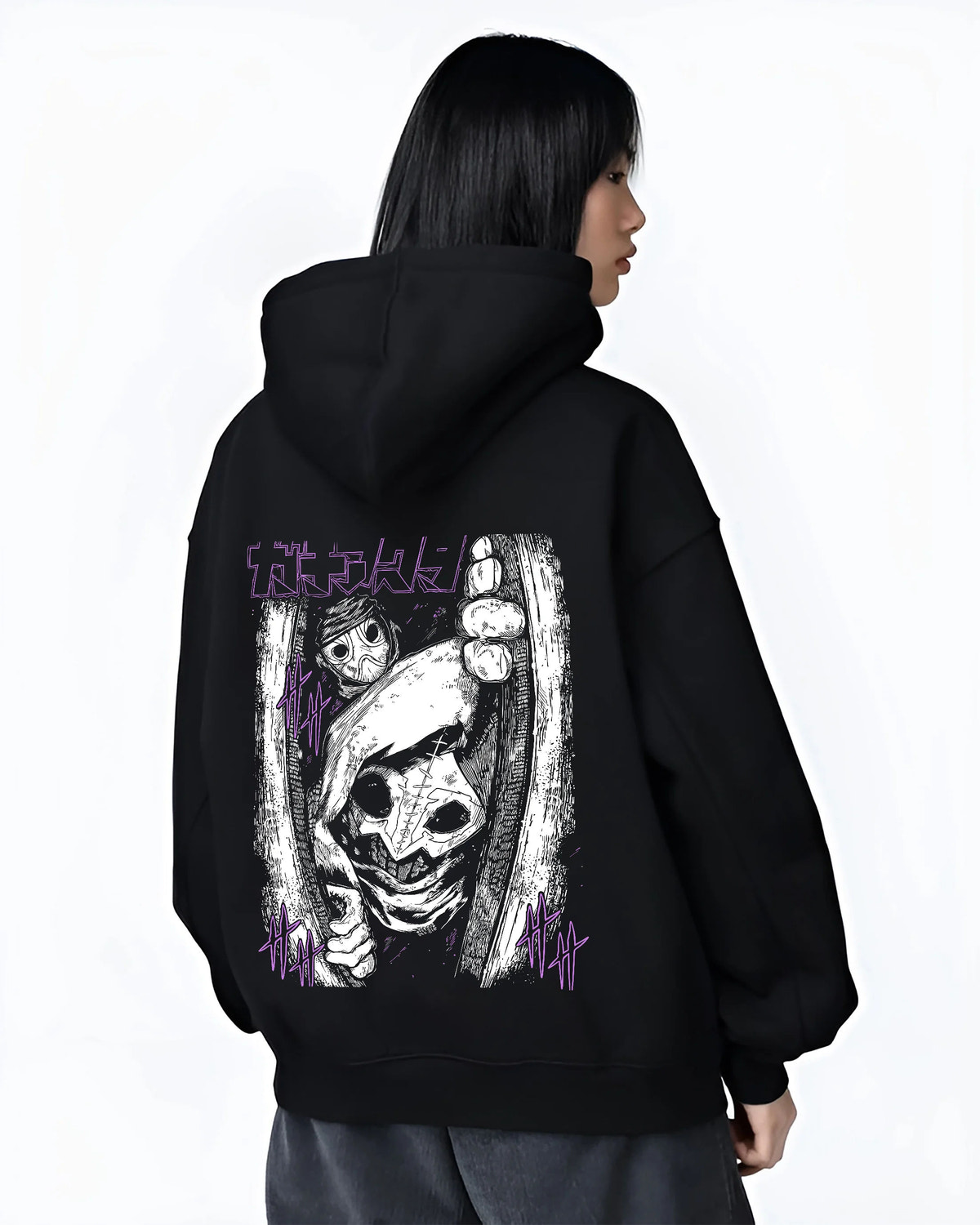 Black hoodie female model back view showing Tamsy from Gachiakuta: eerie close-up mask/pupil