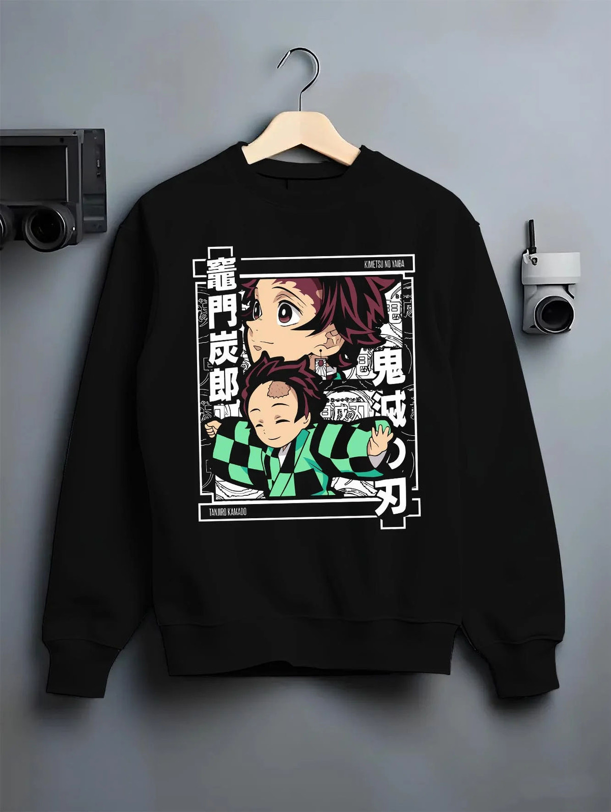 Black crewneck sweatshirt on hanger featuring Tanjiro Kamado chibi family Demon Slayer artwork.