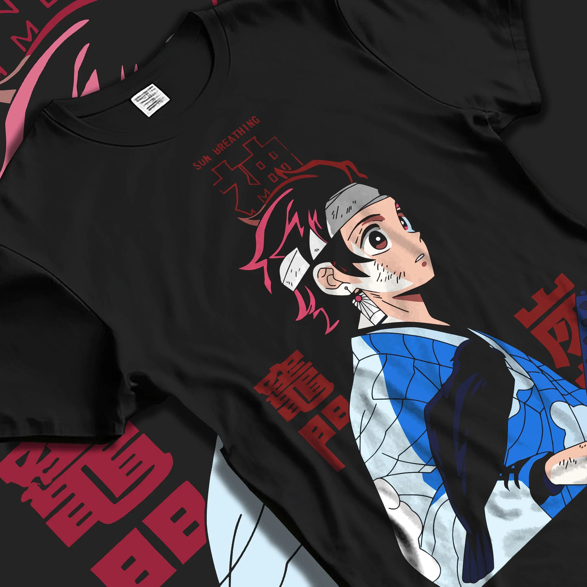 Black T-shirt laid flat with natural folds featuring Tanjiro Kamado Demon Slayer Mark artwork.